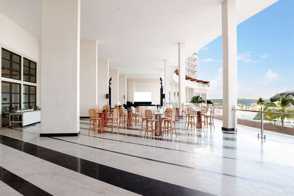 Open-air dining area with wooden tables at a top luxury all-inclusive, perfect for destination weddings.