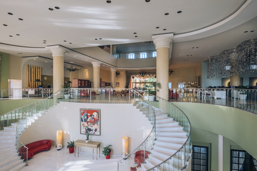 Spiral staircase in a modern hotel lobby, perfect for a luxury destination wedding setting.