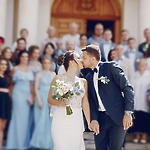 The bride and groom share a kiss while holding hands—a perfect moment for wedding packages designed for 100 guests, ideal for your destination wedding.