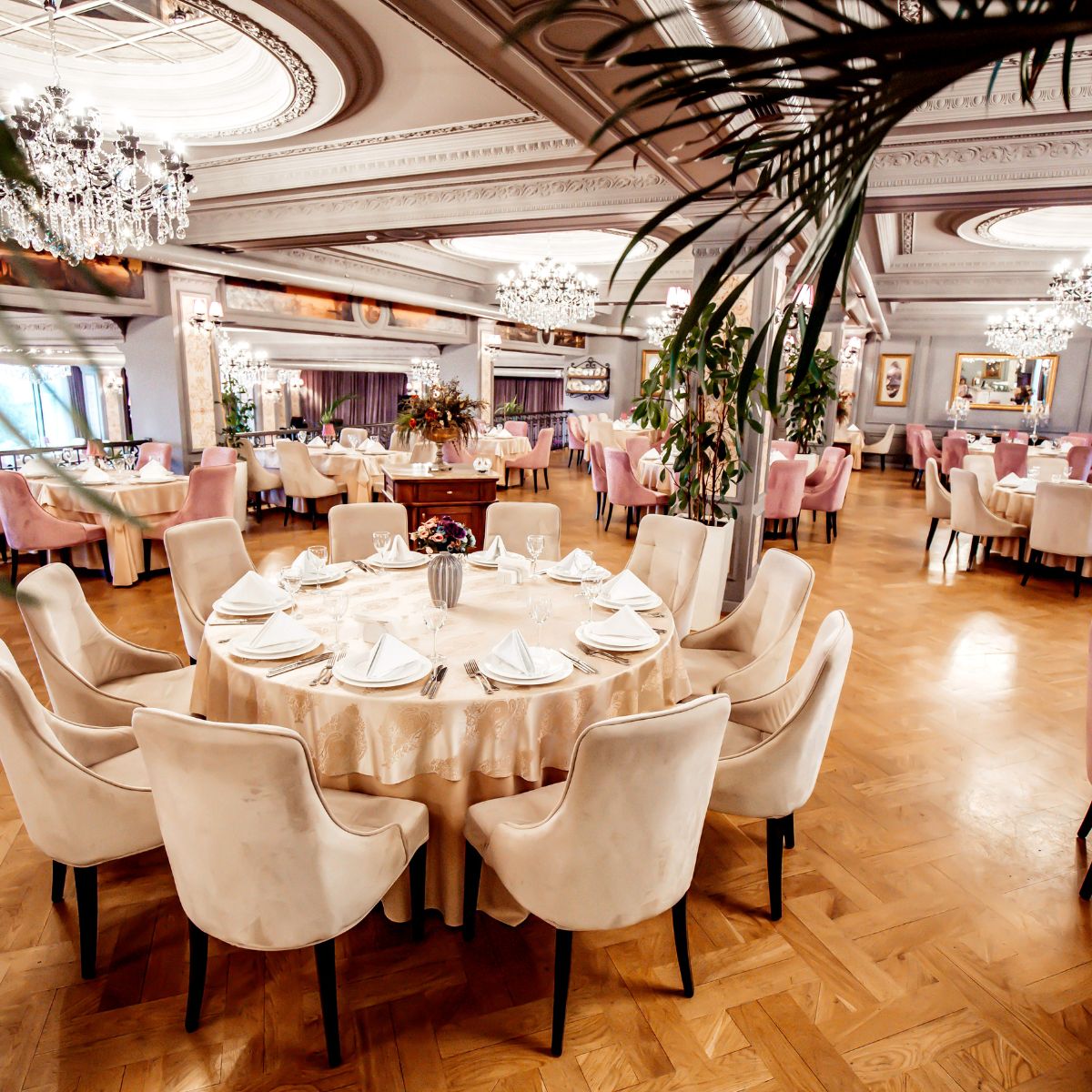 Elegant restaurant dining room, perfect for hosting destination weddings or wedding celebrations of up to 200 guests, featuring sparkling chandeliers for a sophisticated ambiance.