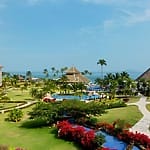 Resort grounds with gardens, pools, palm trees&mdash;perfect destination wedding views at Panama Jack Cancun.