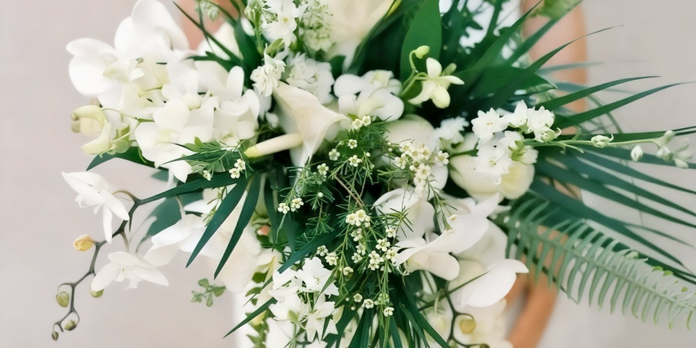 A beautiful bouquet of white flowers and lush greenery, ideal for a spring wedding or destination wedding celebration.