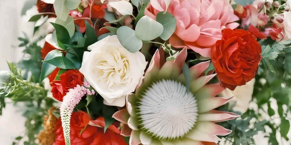 A beautiful bouquet featuring white, pink, and red blooms—perfect for a romantic wedding or a vibrant destination wedding celebration.