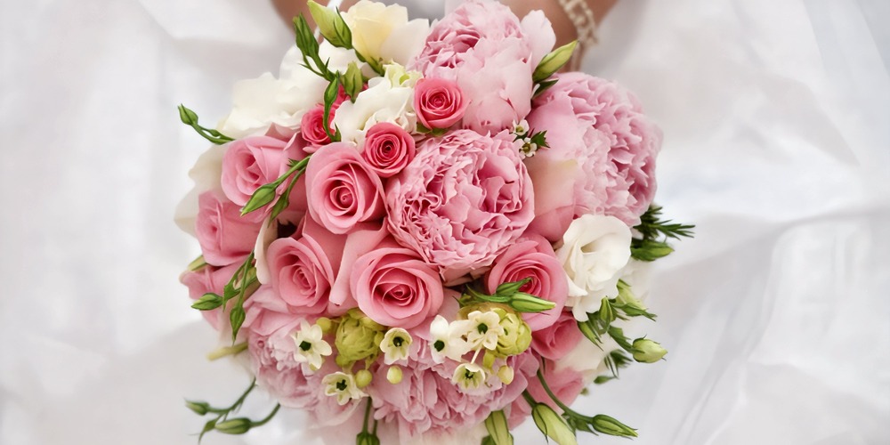 A beautiful bouquet of pink roses, peonies, and white blooms—perfect for a romantic wedding or a dreamy destination wedding in the spring.