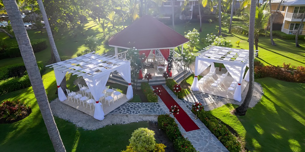 Charming outdoor wedding venue featuring a gazebo, tents, and red carpet&mdash;ideal for destination weddings.
