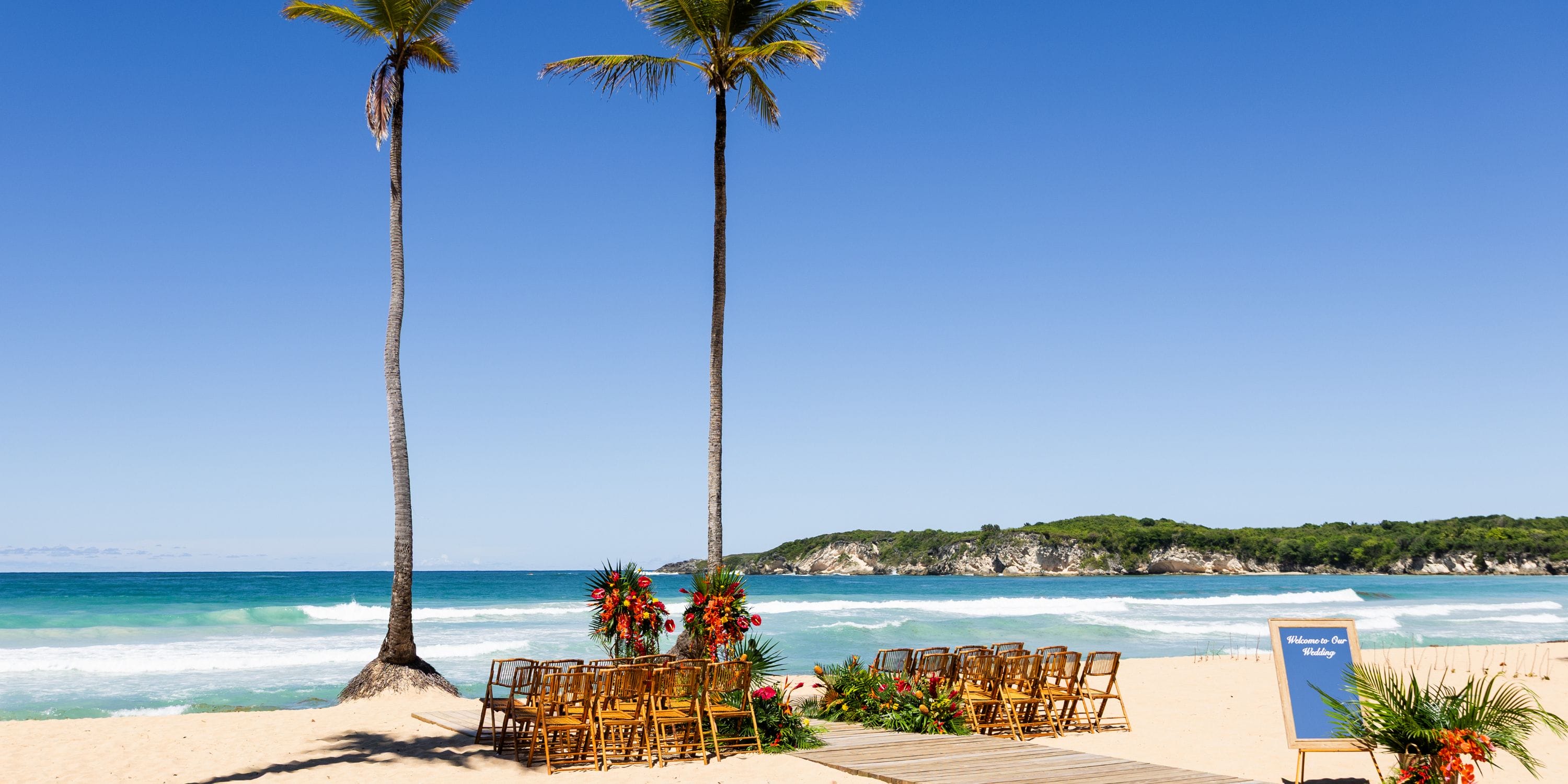 Flowers and chairs arranged for a destination wedding at Dreams Macao Beach overlooking the ocean.