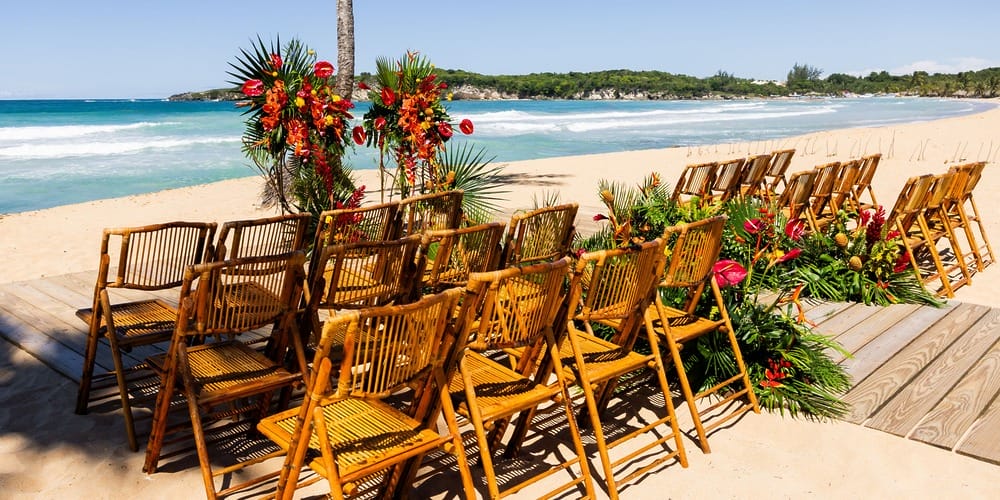 Dreams Macao Beach showcases bamboo chairs and floral decor for a stunning destination wedding ceremony.