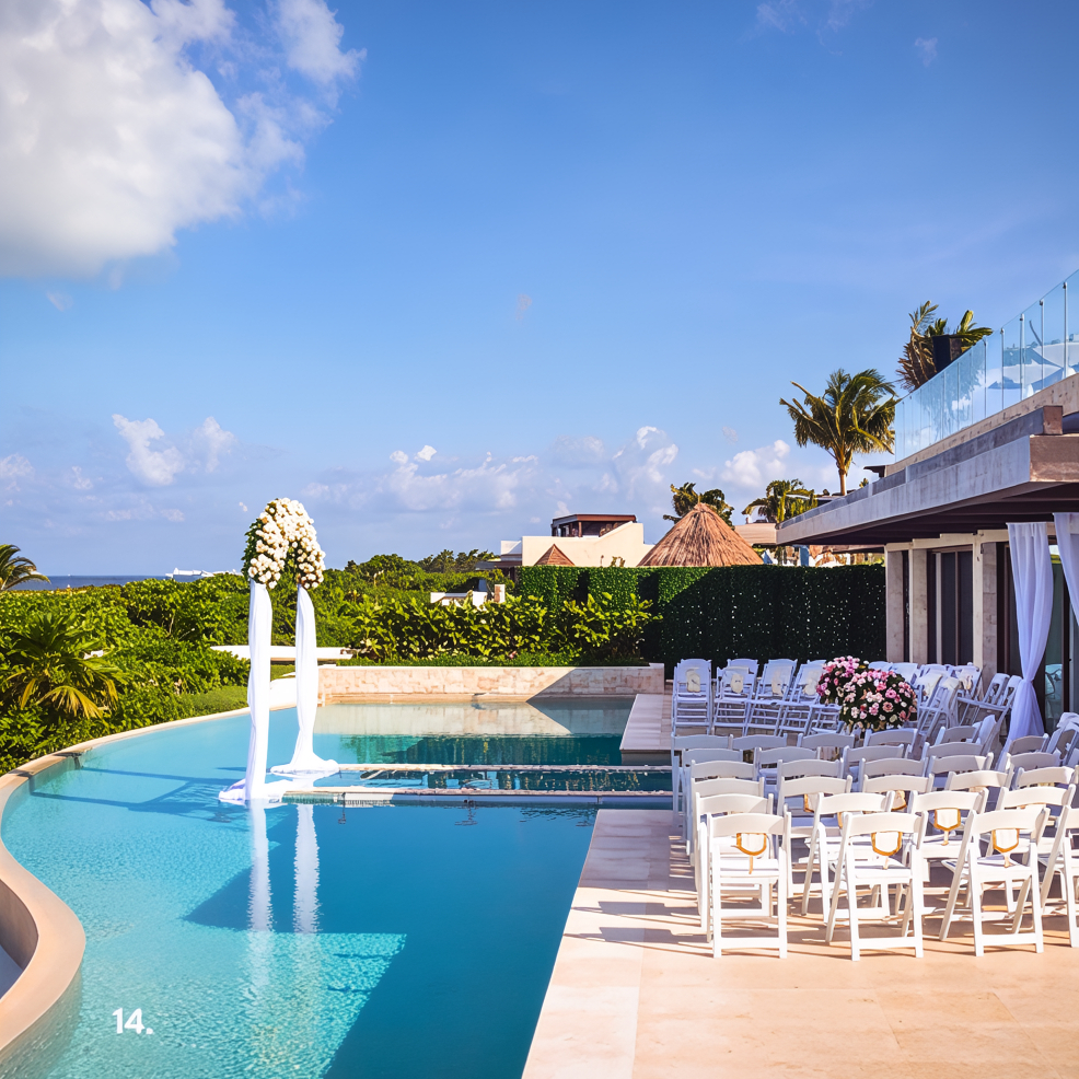 Destination wedding ceremony by a pool, featuring white chairs and elegant floral decorations.