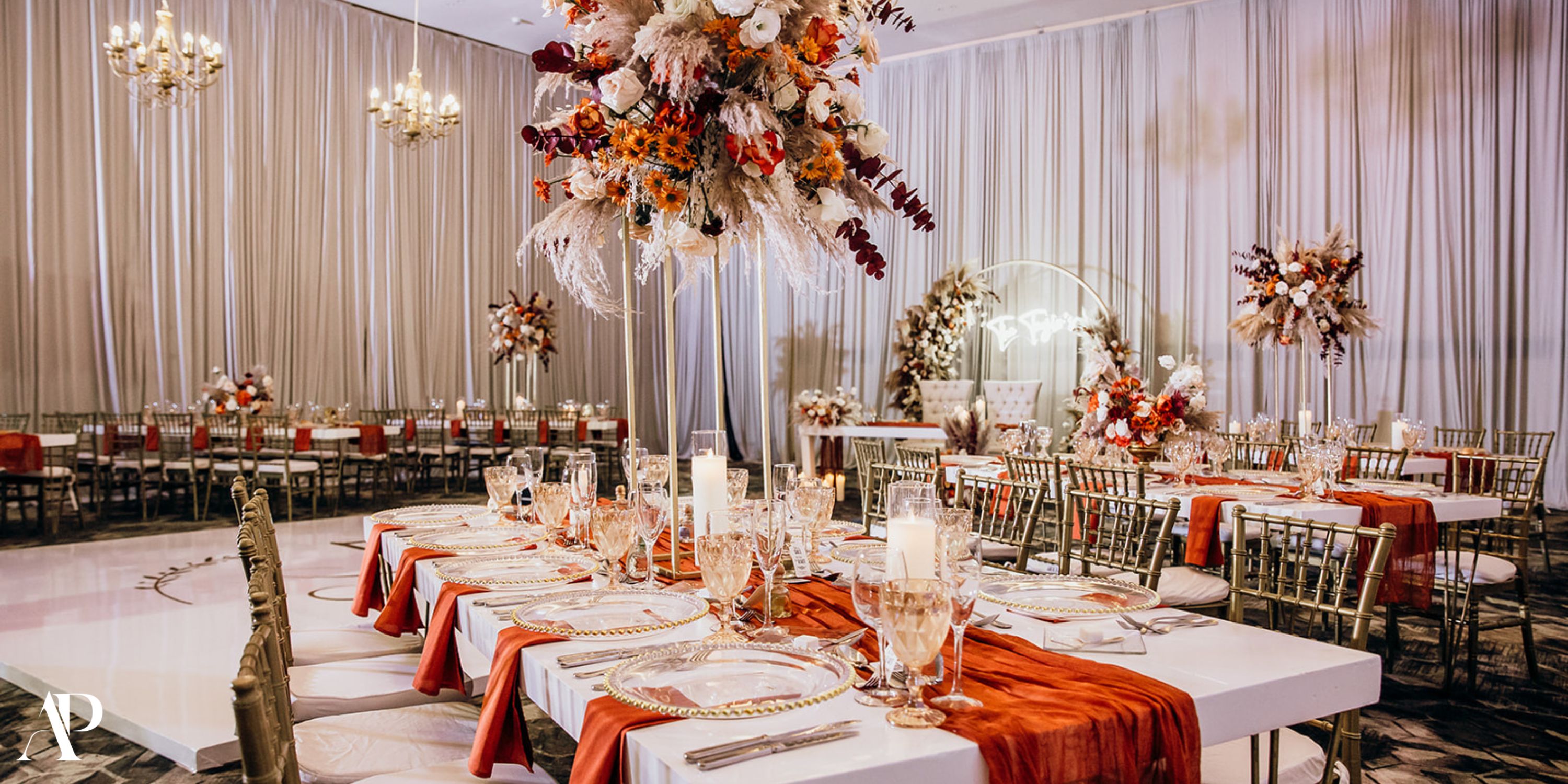 Dreams Riviera Cancun destination wedding banquet hall with elegant tables, floral centerpieces, and drapes.