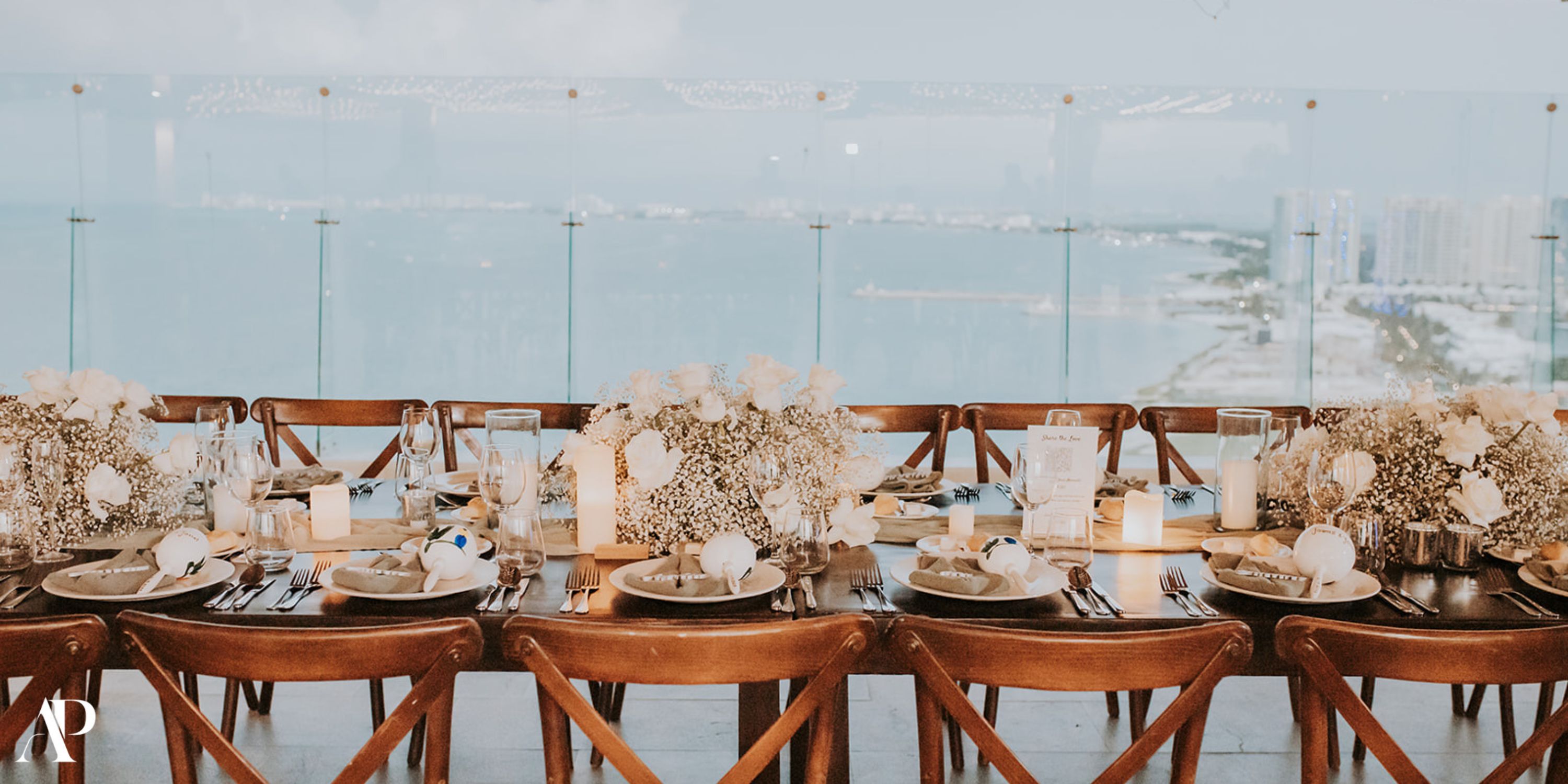 Elegant table set for a destination wedding at Dreams Vista Cancun, with white flowers and city views.
