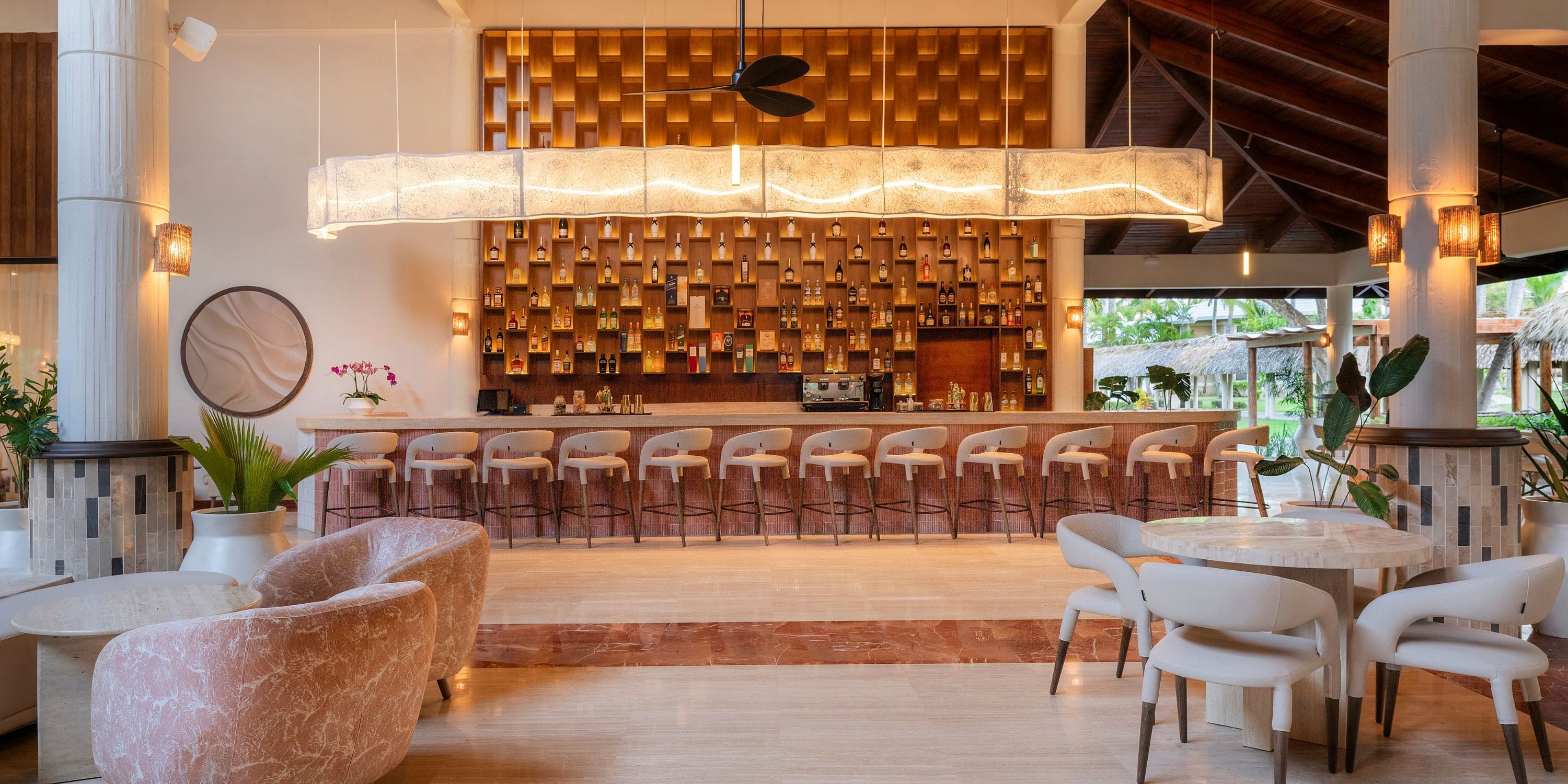 Grand Palladium Bavaro&rsquo;s bar, ideal for a destination wedding, has marble seats and wood accents.