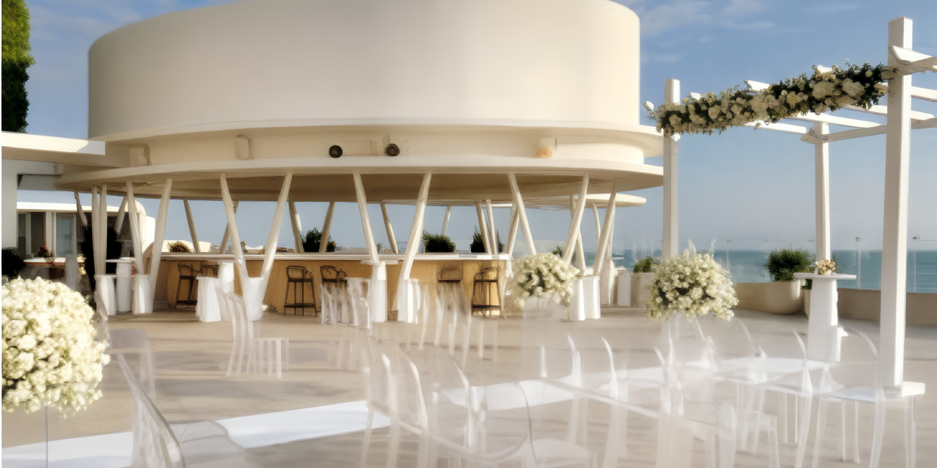 Grand Palladium Costa Mujeres features a modern wedding venue with ocean views and elegant white floral decor.
