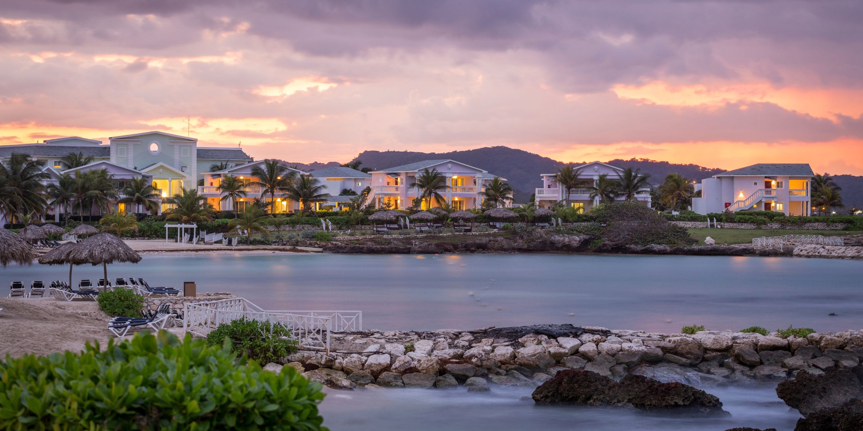 Grand Palladium Jamaica resort by calm water at sunset, ideal for a destination wedding.