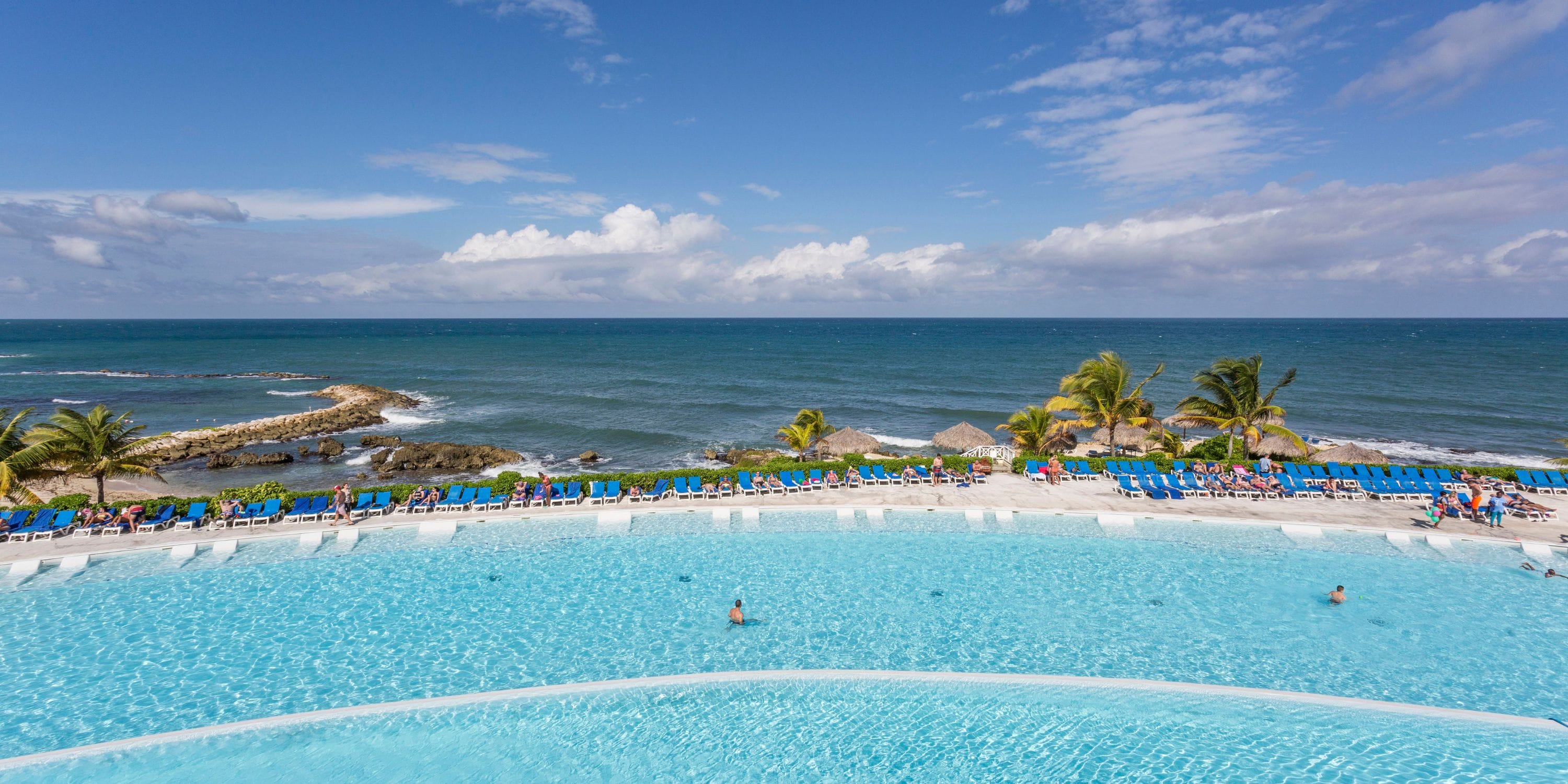 Grand Palladium Jamaica: Perfect outdoor pool for a destination wedding, blue loungers, ocean view.