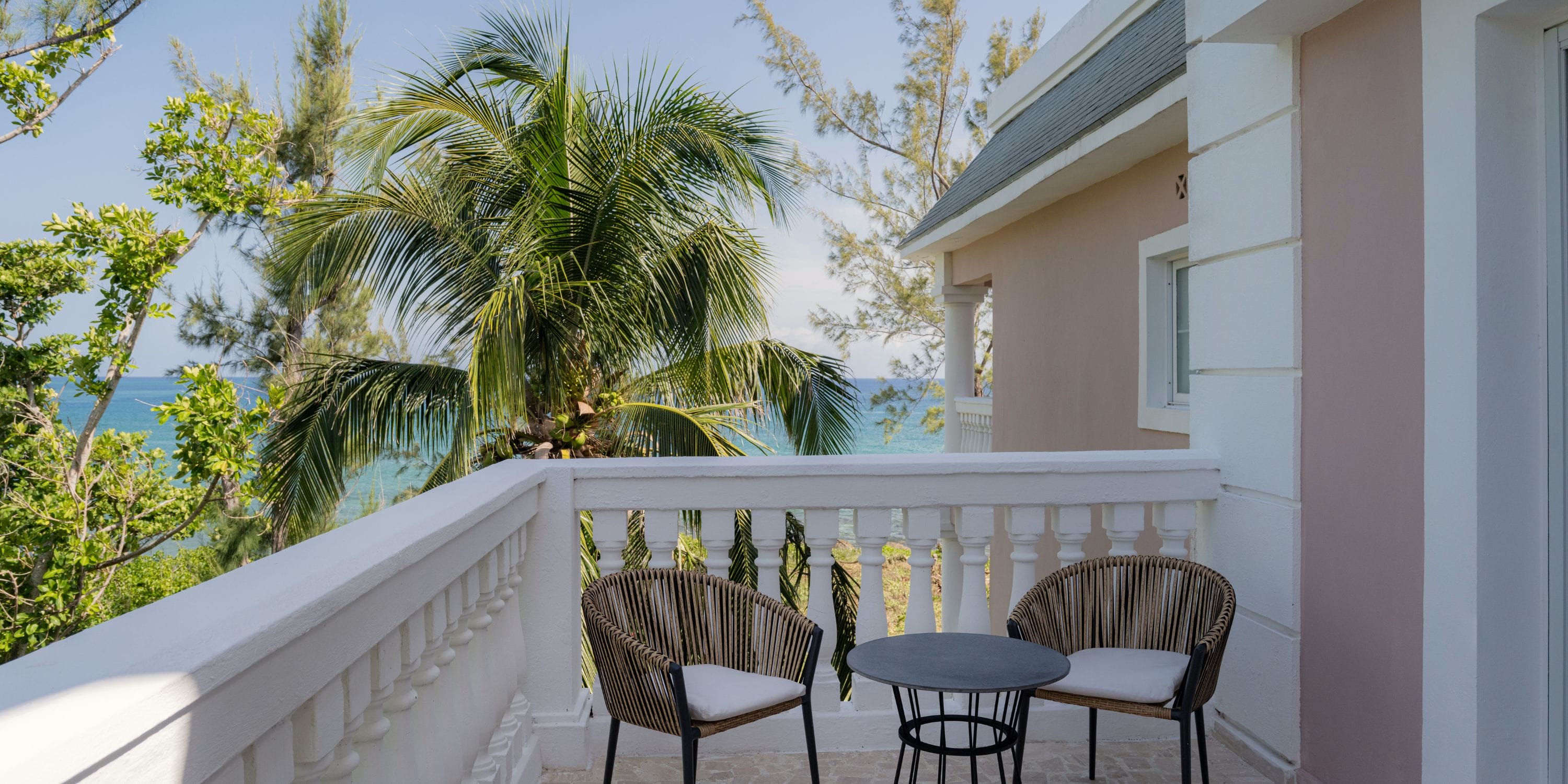 Balcony at Grand Palladium Jamaica, perfect for a destination wedding, overlooks palms and ocean.