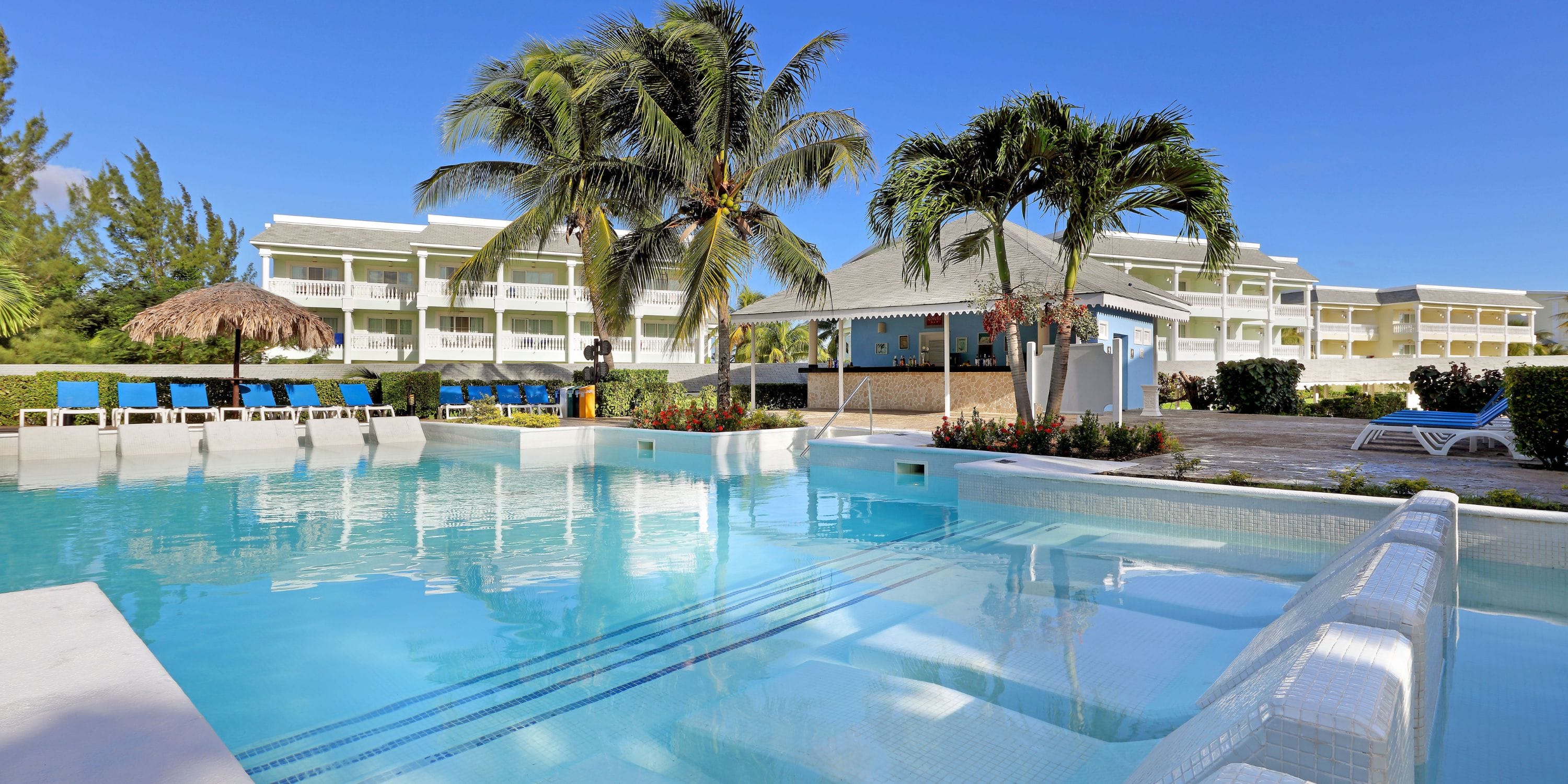 Grand Palladium Jamaica: dreamy pool, palms, and hotel—perfect for a tropical destination wedding.