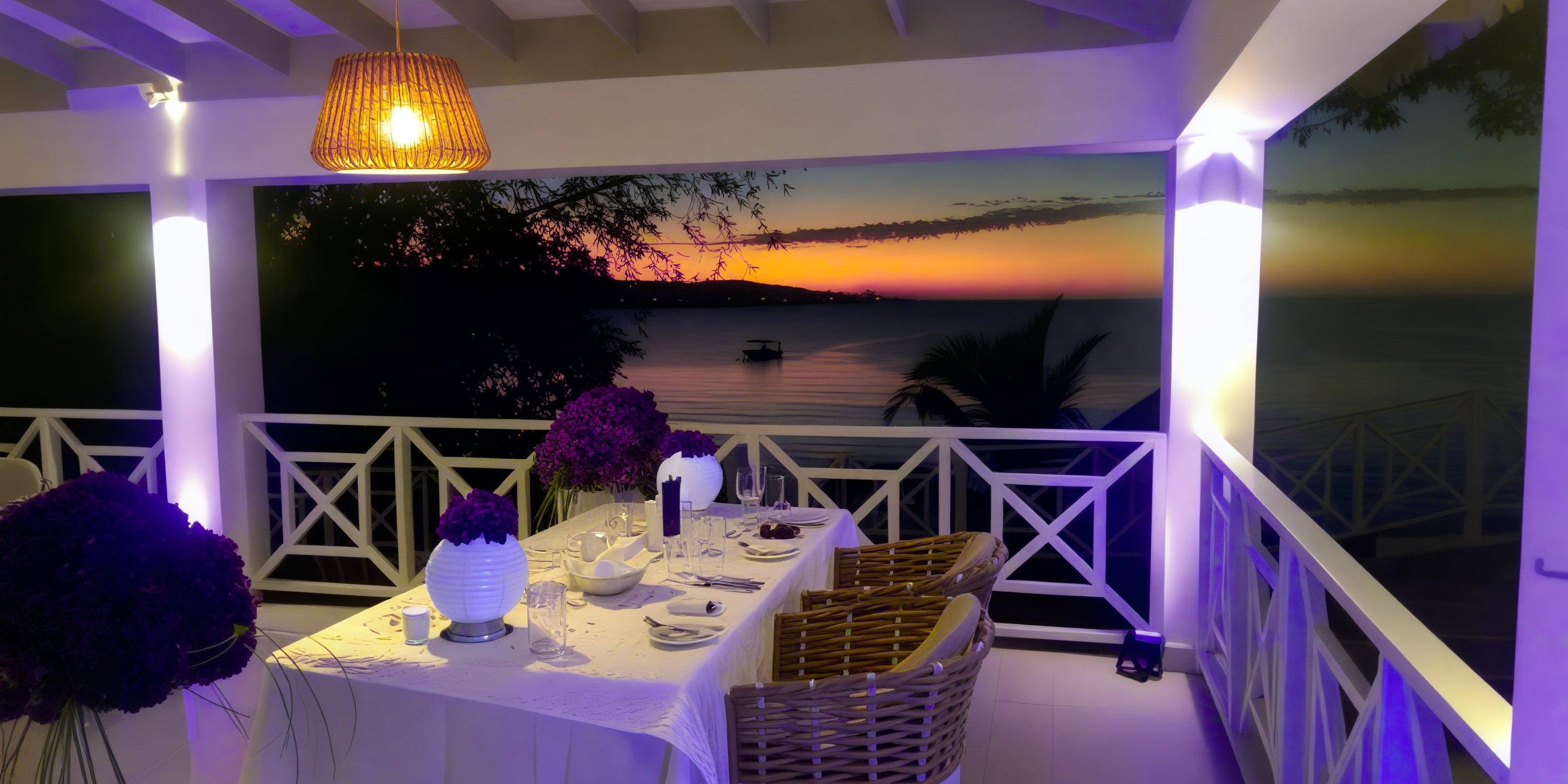A set table on a veranda at Grand Palladium Jamaica is prepared for a destination wedding at sunset.