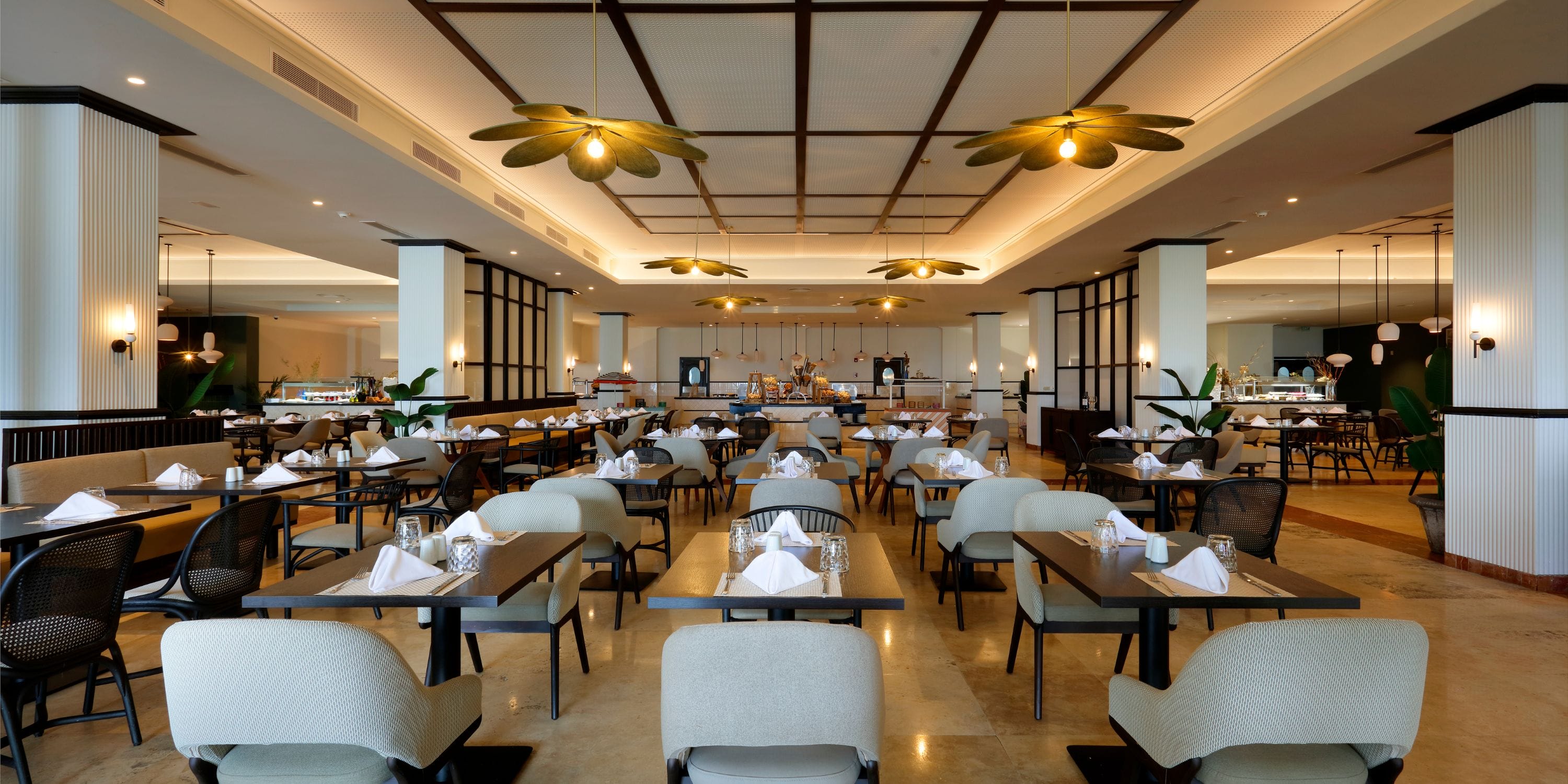 Elegant Grand Palladium Jamaica restaurant, set for a destination wedding, buffet in the background.