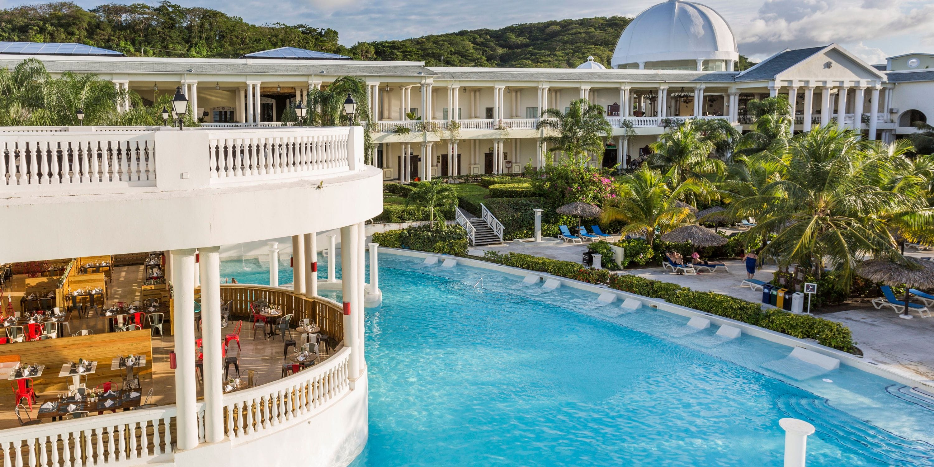 Grand Palladium Jamaica: pool, palms, outdoor dining—perfect for your destination wedding.