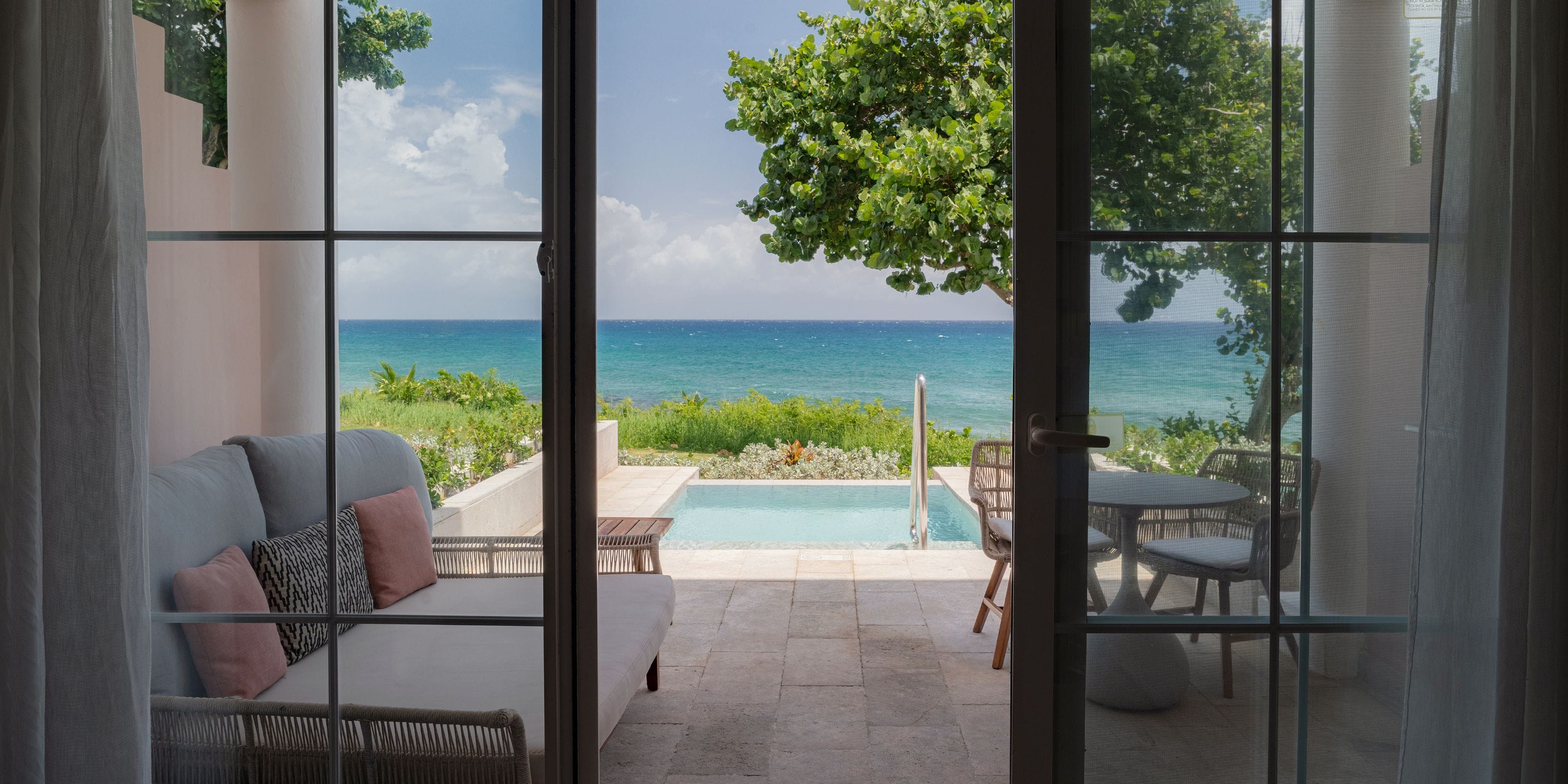Patio at Grand Palladium Jamaica perfect for a destination wedding, with pool, trees, and seating.