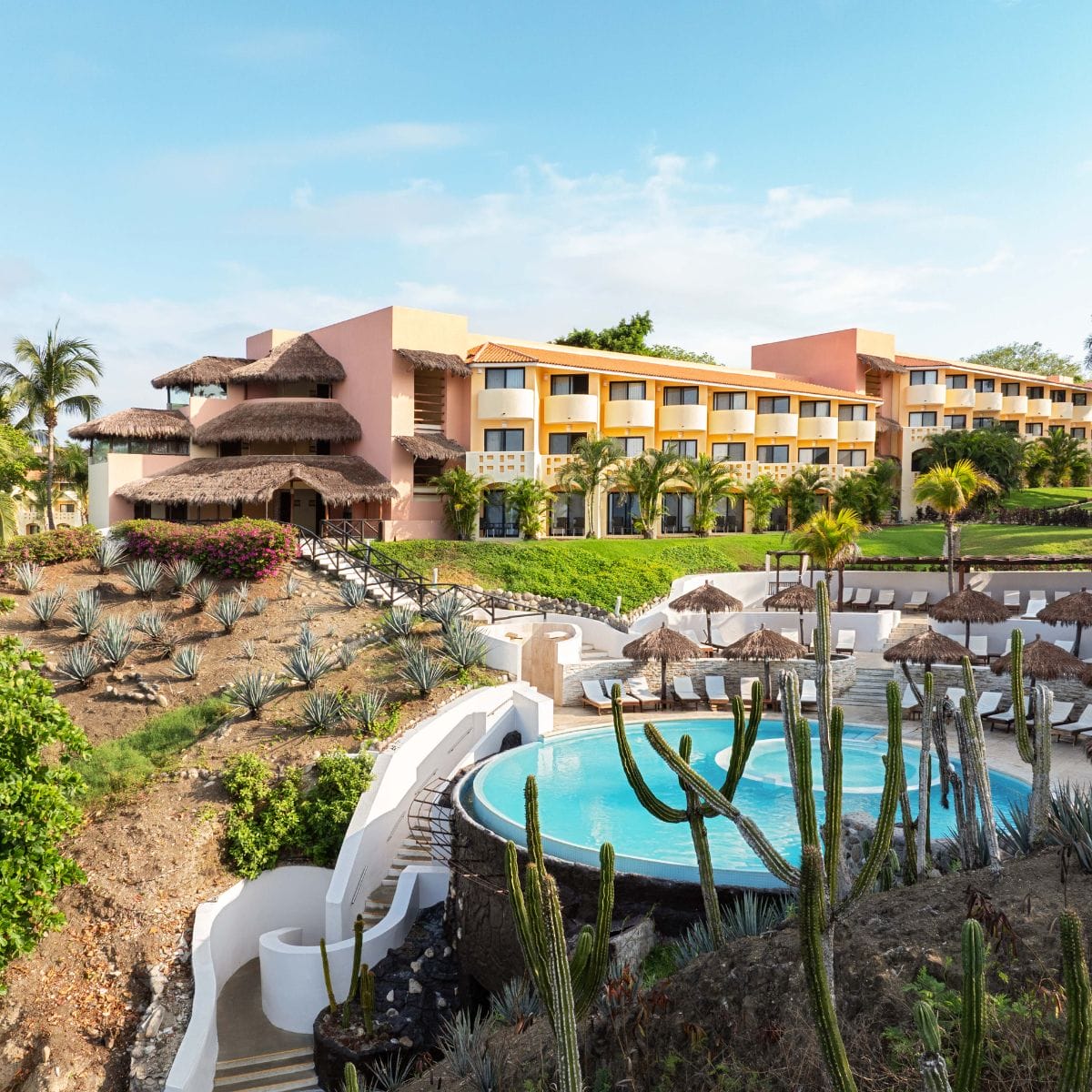 Grand Palladium Vallarta: ideal for a destination wedding, straw-roofed hotel, pool, cacti, agave.