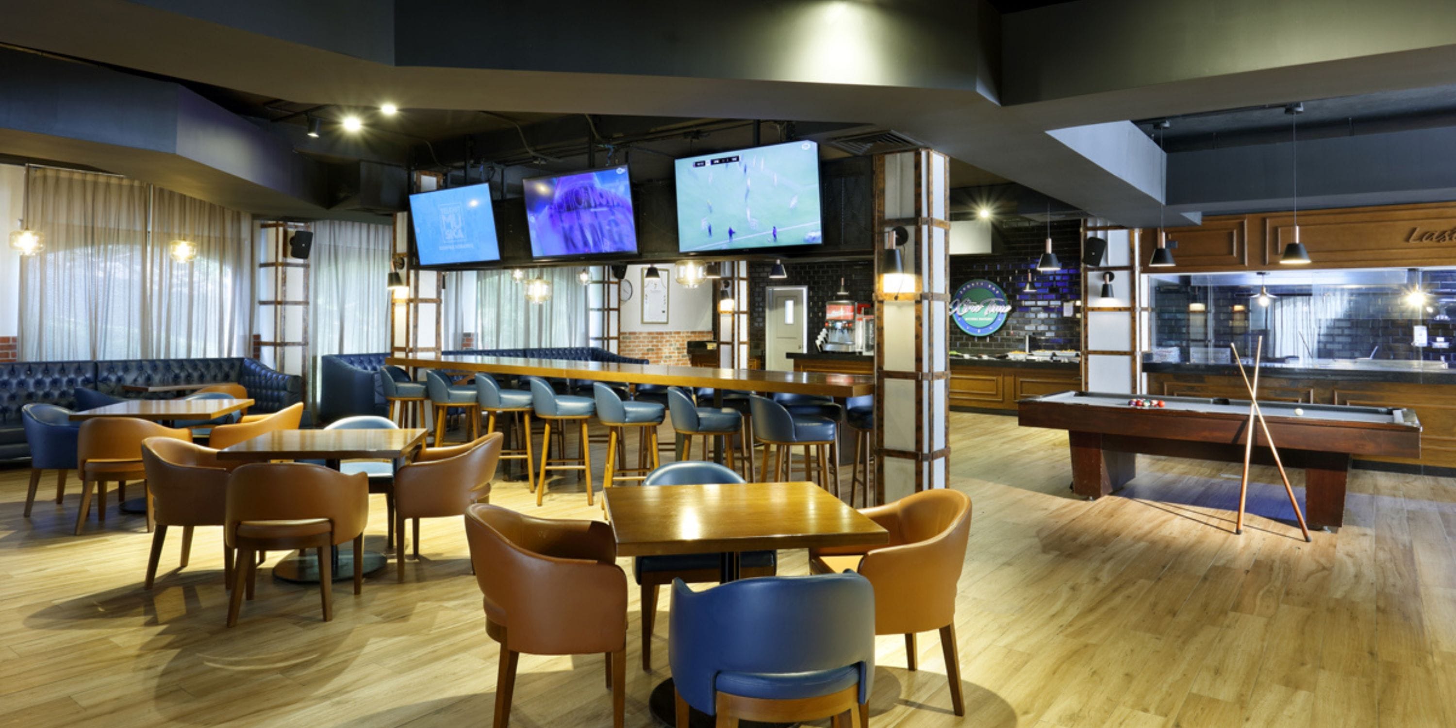 Chic sports bar at Grand Palladium Vallarta, ideal for destination wedding fun: tables, pool table.