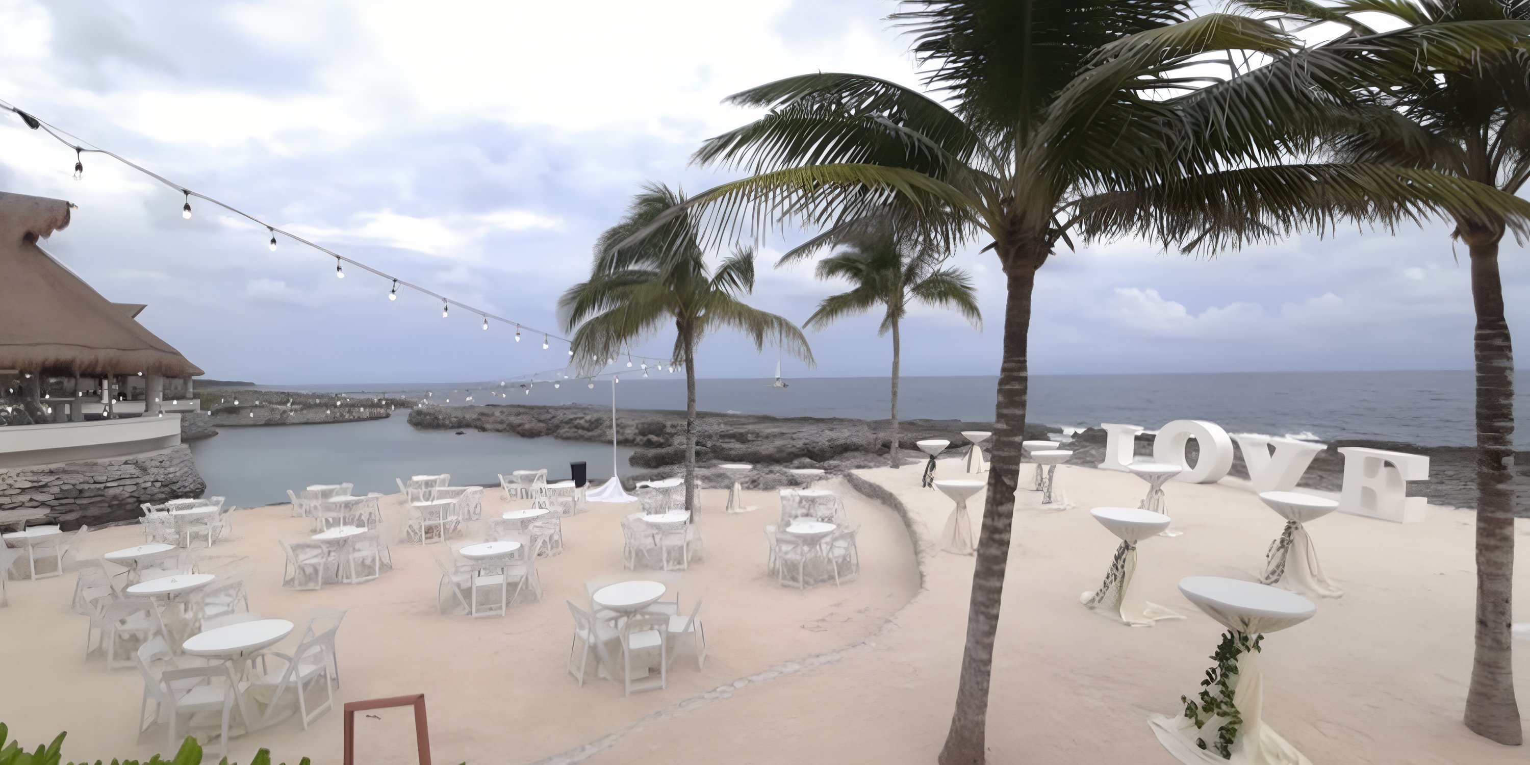 Destination wedding at Hard Rock Riviera Maya featuring LOVE letters displayed along the seaside.