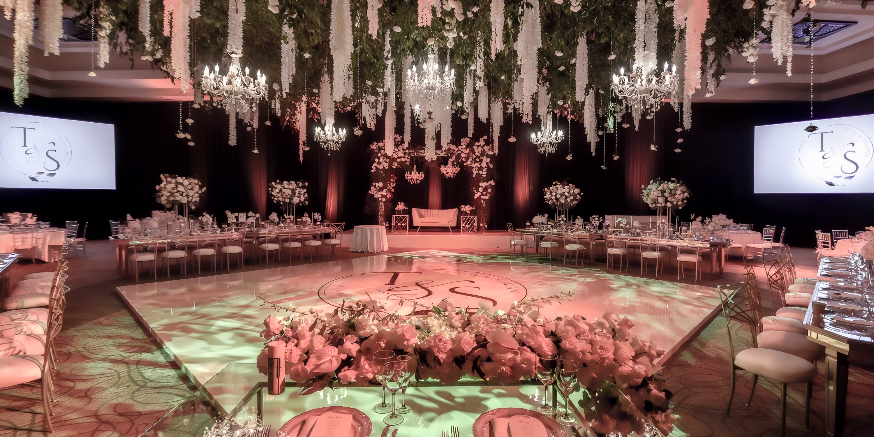 Chic destination wedding reception at Hyatt Ziva Los Cabos with lush florals and custom dance floor.