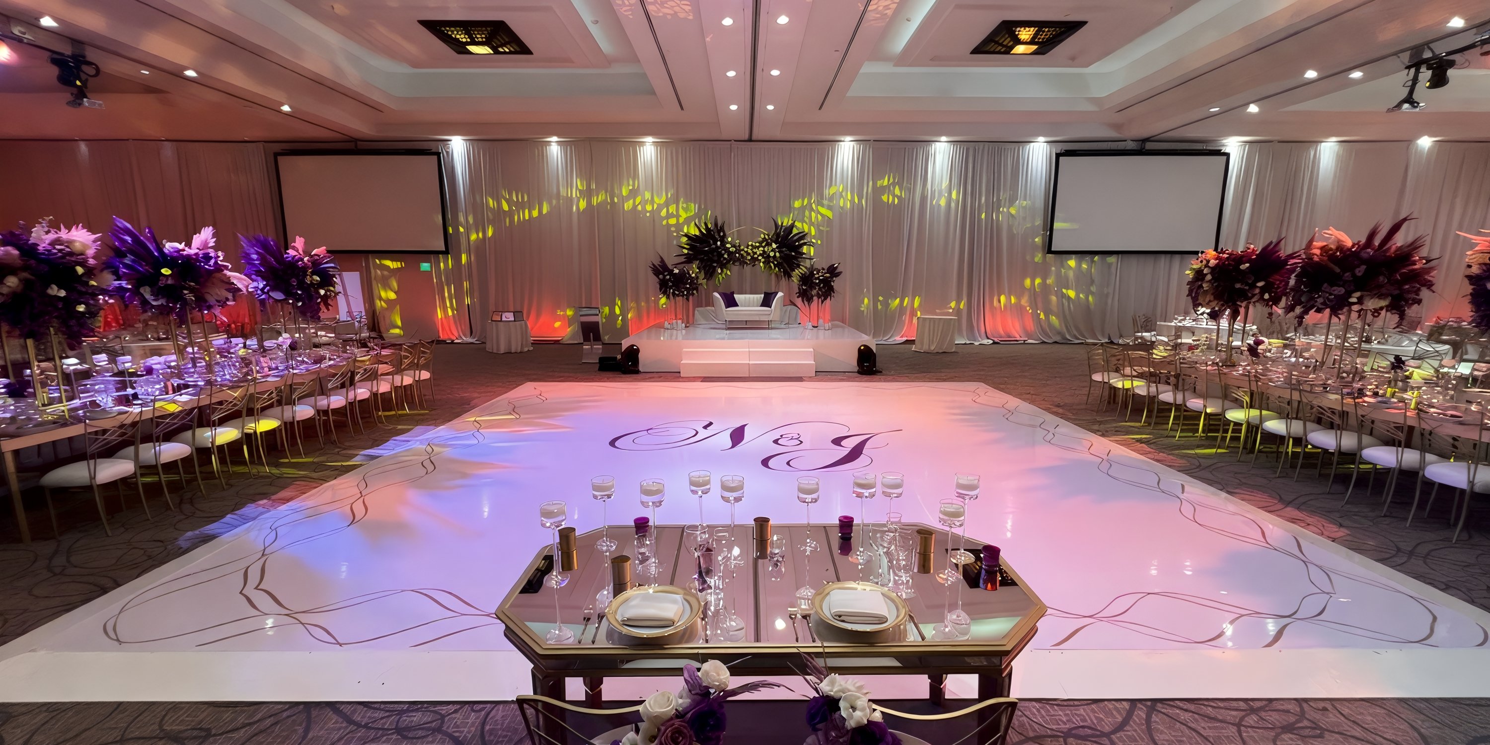 Chic destination wedding scene with beautifully adorned tables and dance floor at Hyatt Ziva Los Cabos.