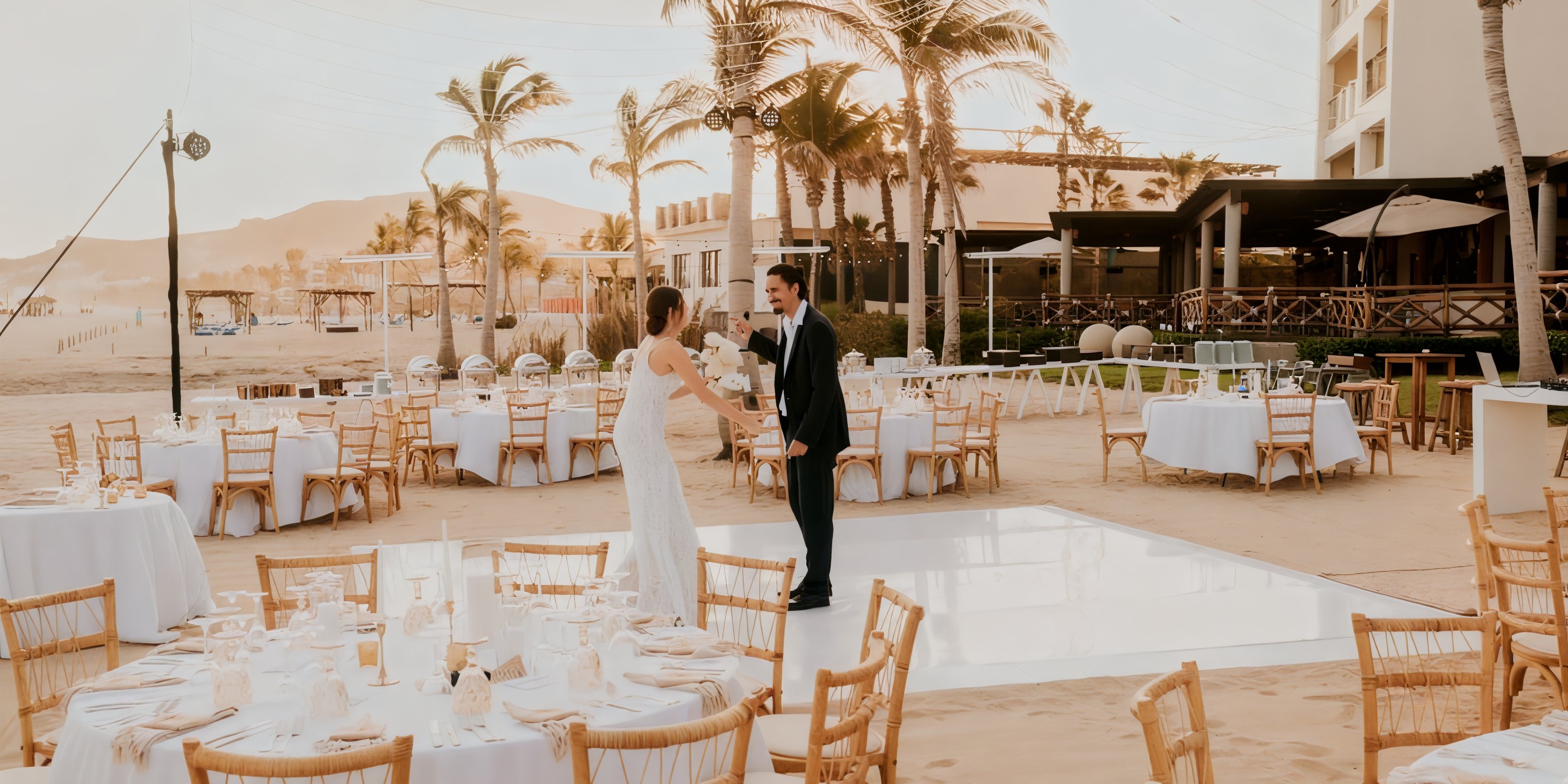 Bride and groom share a dance at their destination wedding outdoors at Hyatt Ziva, tables decorated around.