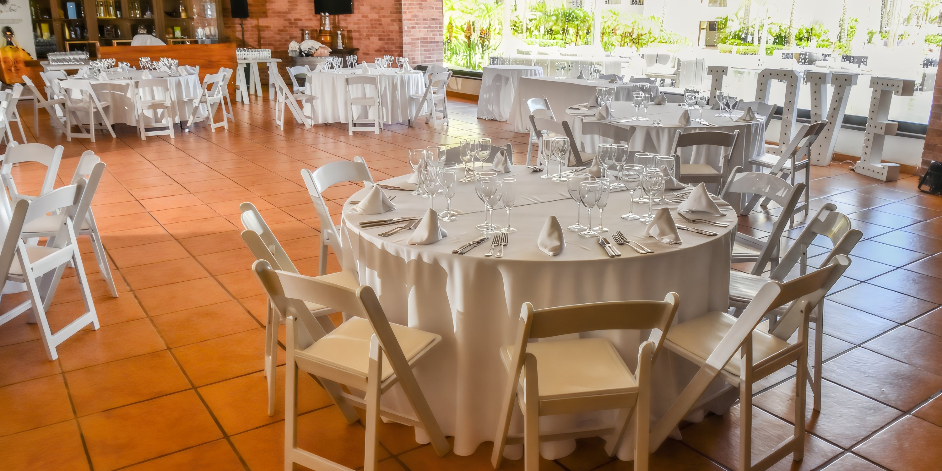Hyatt Ziva Los Cabos: elegant indoor wedding venue featuring round tables and white chairs.
