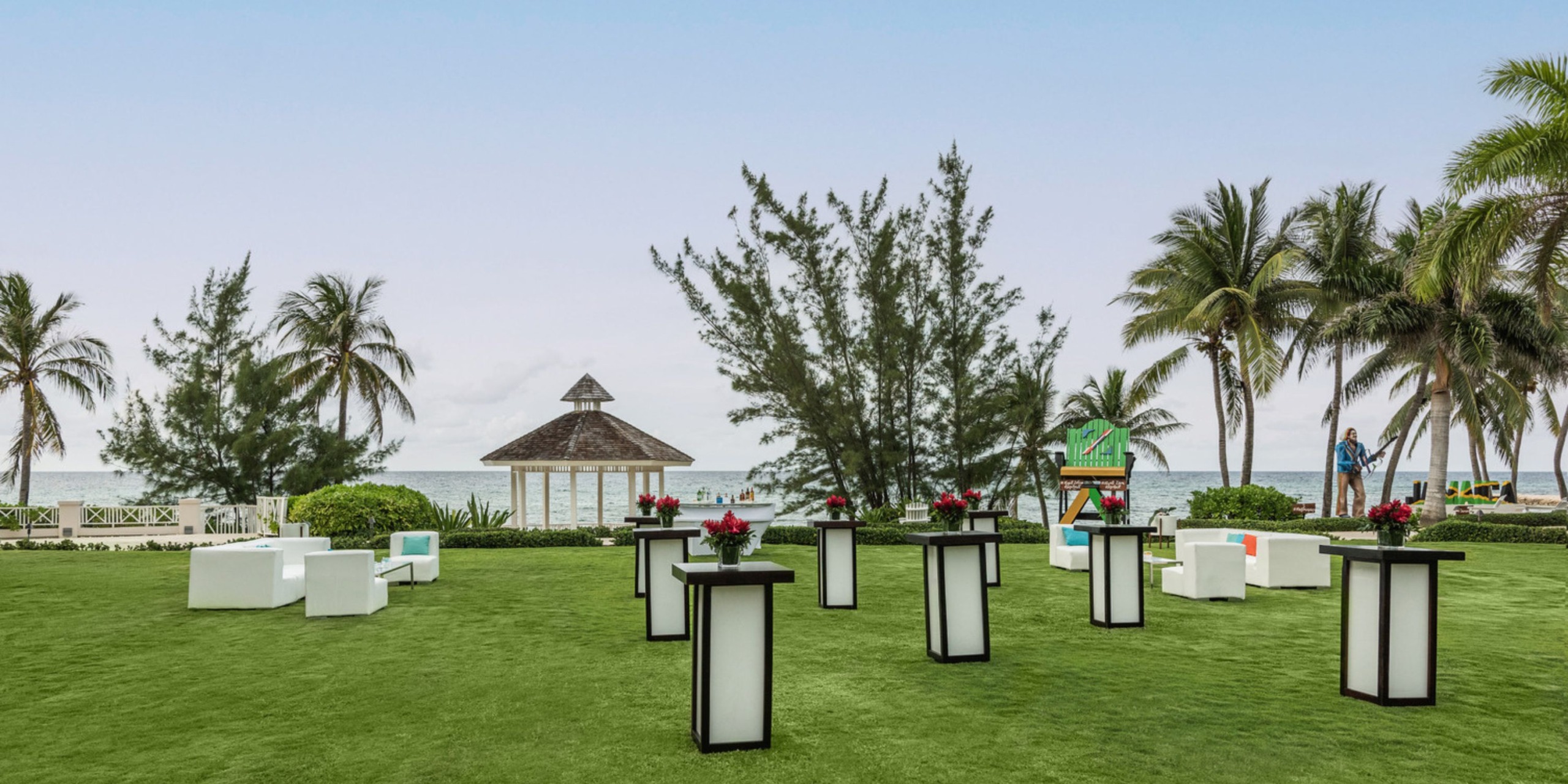 Destination wedding at Hyatt Zilara Rose Hall featuring elegant tall tables and a picturesque sea-view gazebo.