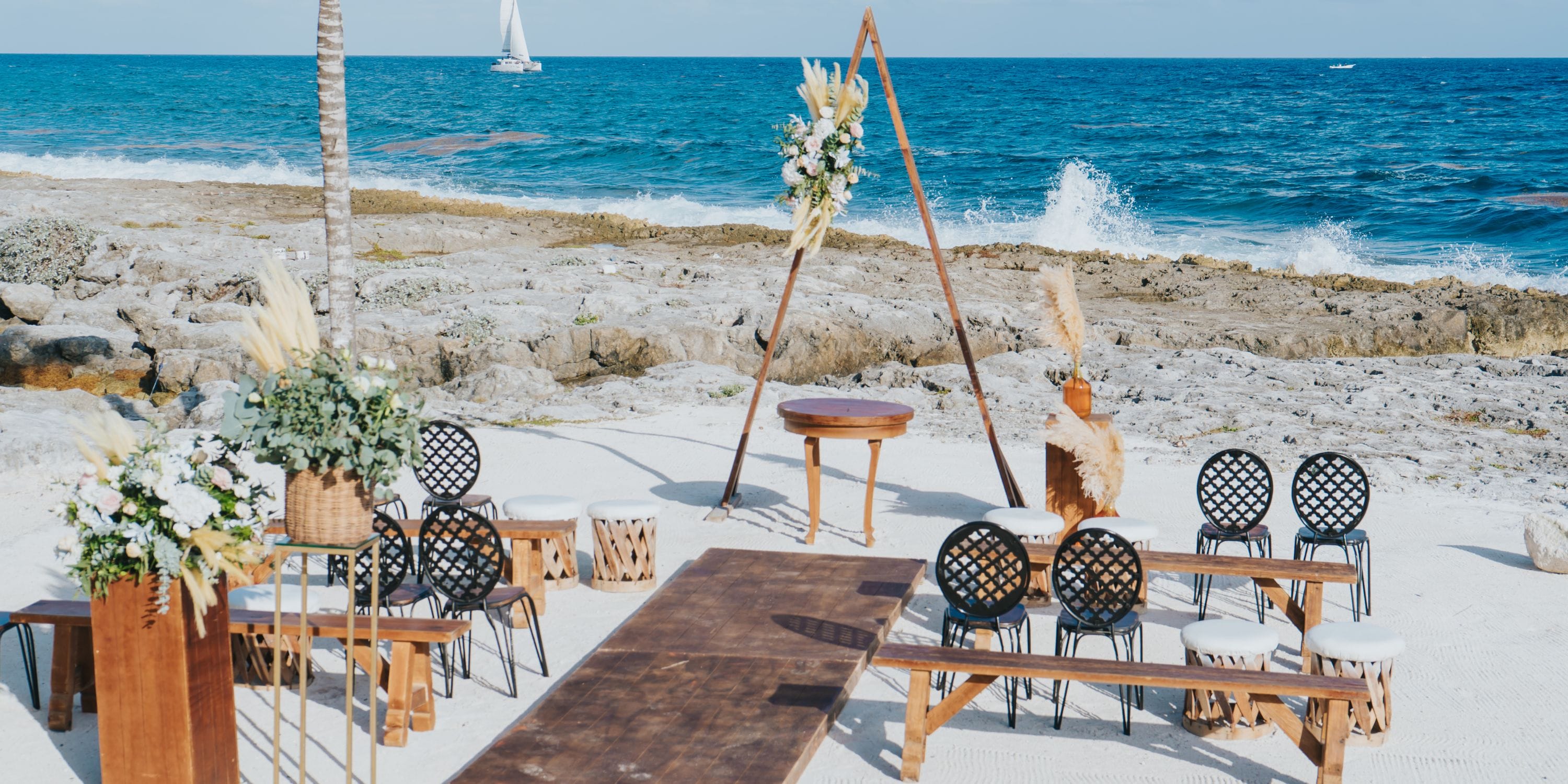 Destination wedding setup at Hard Rock Riviera Maya featuring chairs, florals, and stunning ocean views.