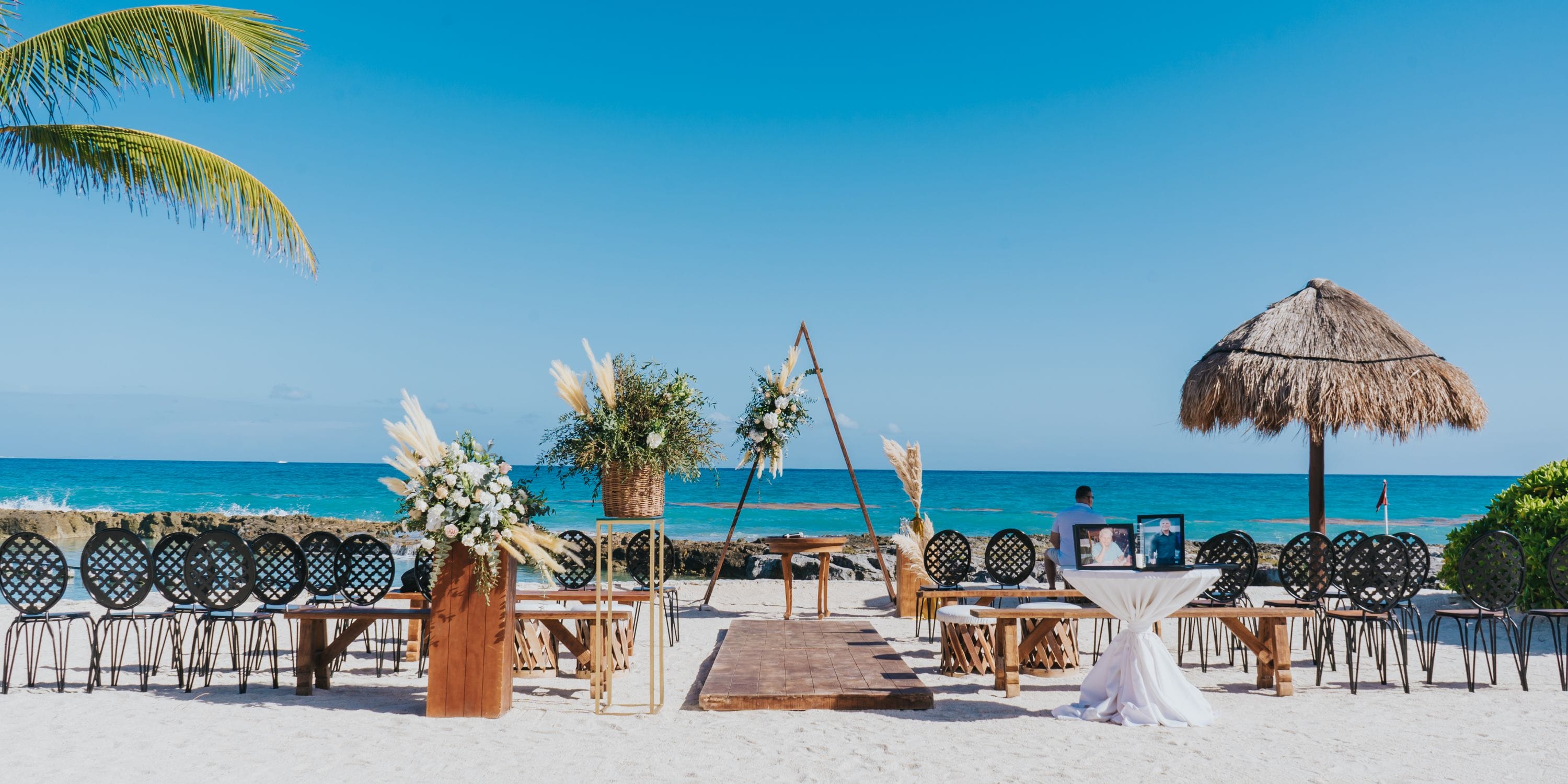 Destination wedding ceremony setup on the beach at Hard Rock Riviera Maya resort, overlooking the ocean.