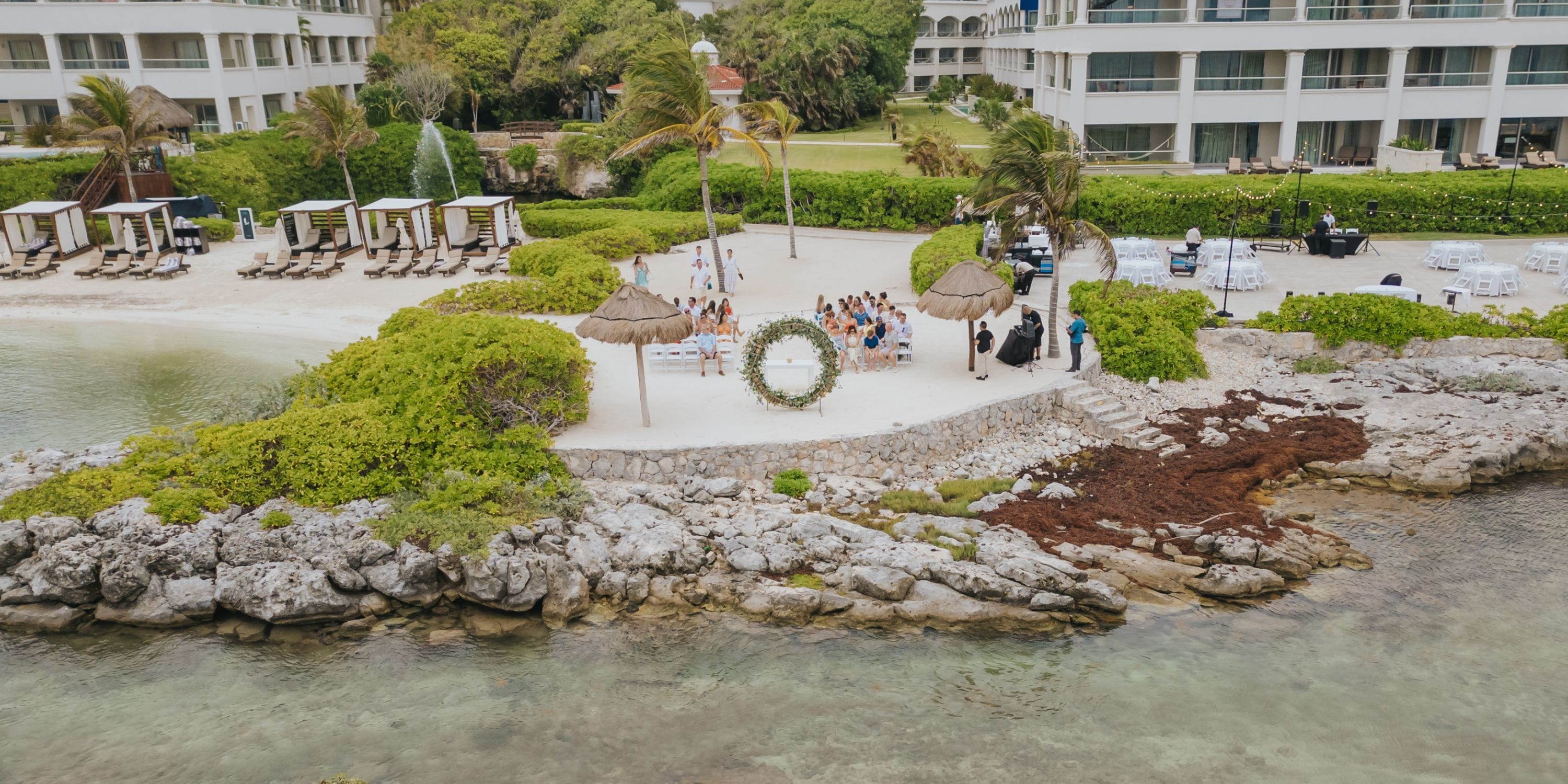 Destination wedding ceremony setup on a small beach at Hard Rock Riviera Maya resort.