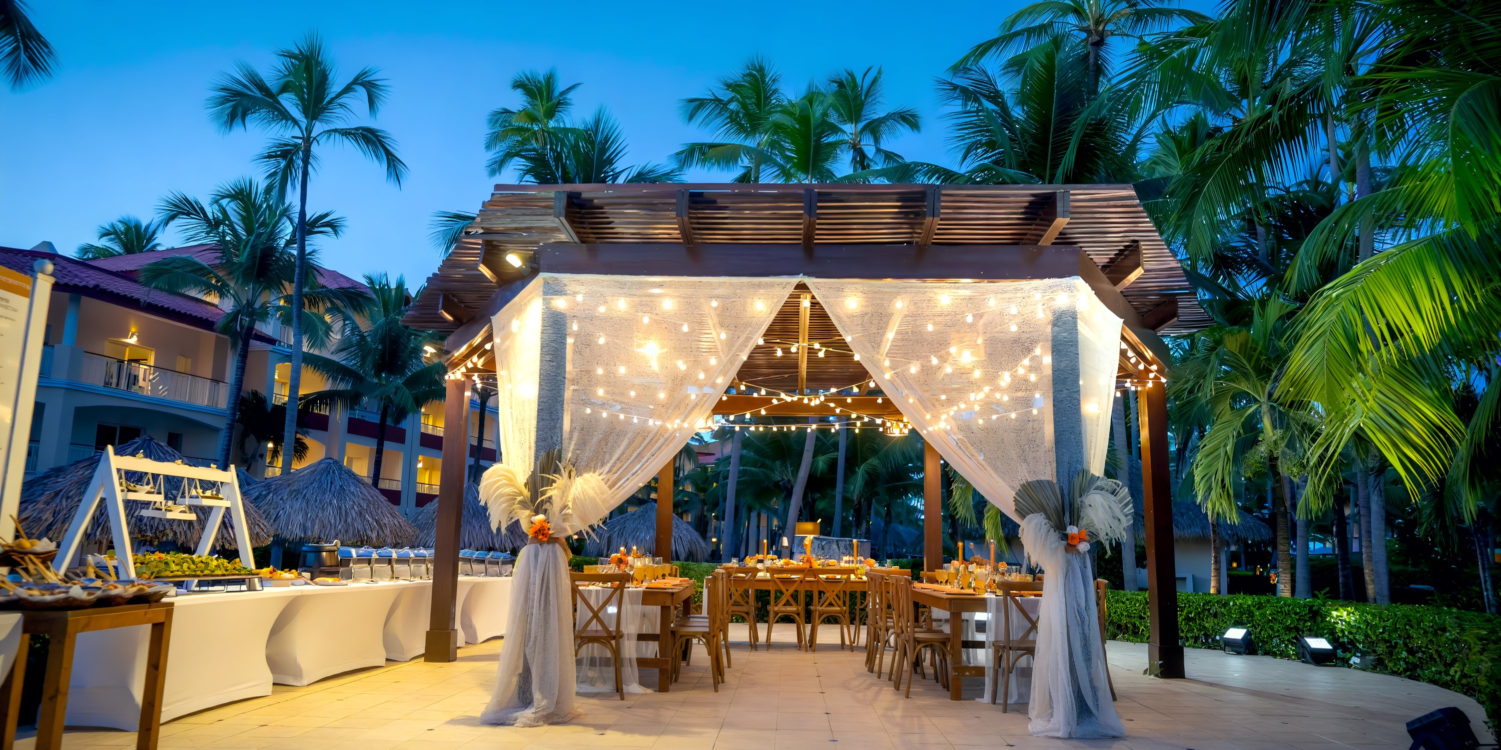 Gazebo at Majestic Elegance Punta Cana with string lights and white drapes, perfect for a destination wedding.
