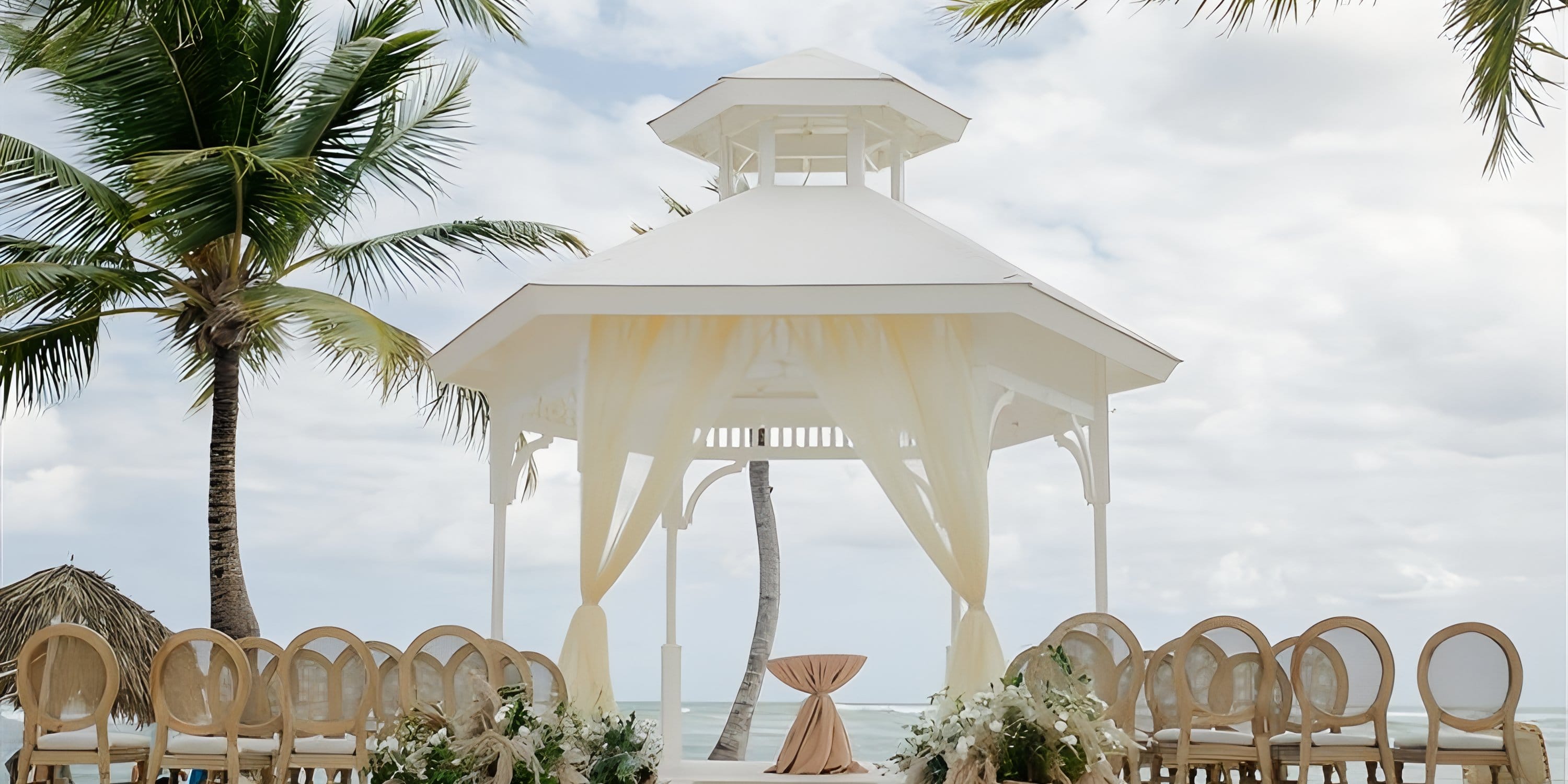 Elegant white gazebo with drapes set up for a destination wedding at Majestic Mirage Punta Cana.