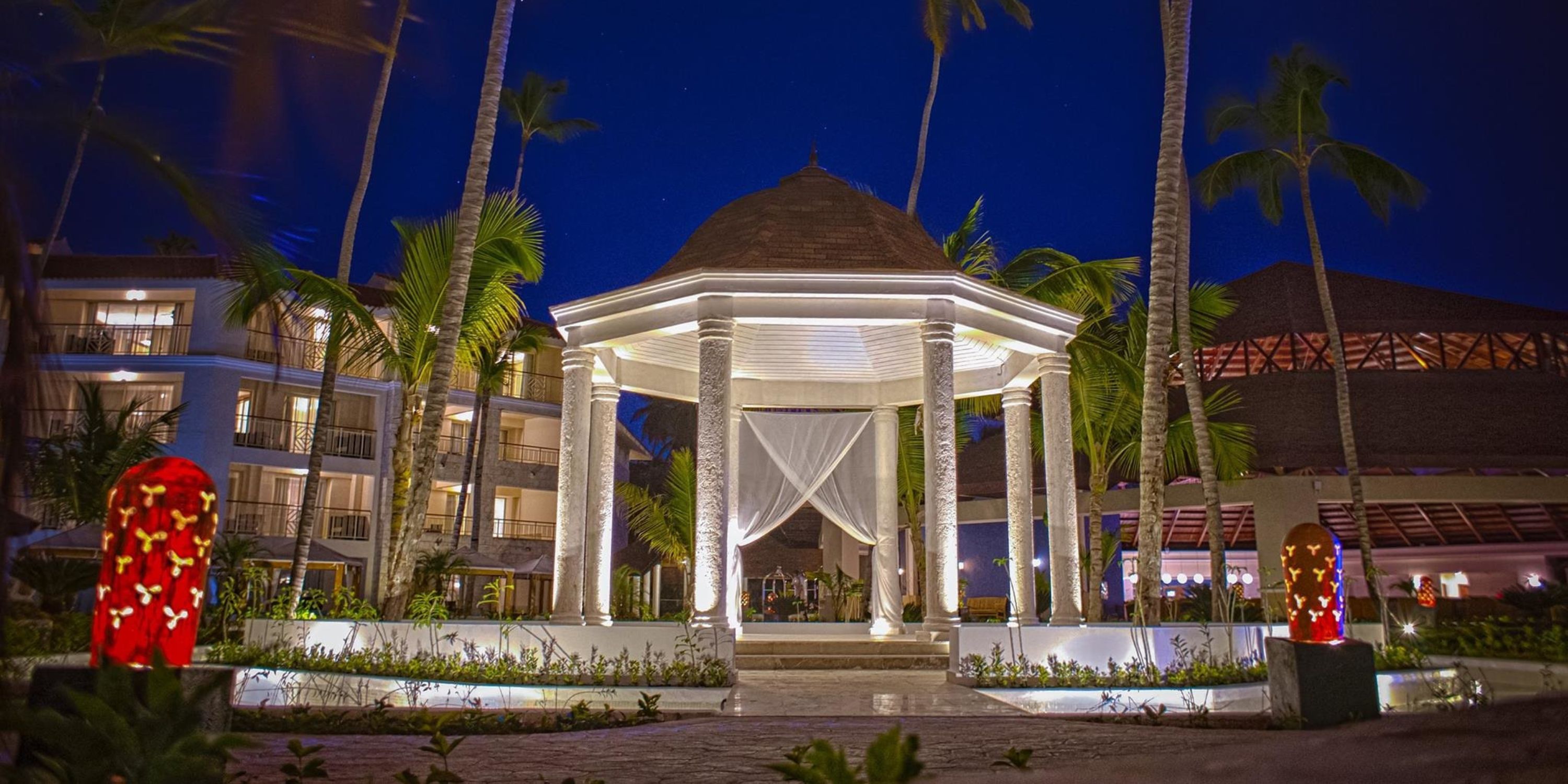 Glowing gazebo with flowing curtains, perfect for a Majestic Mirage Punta Cana destination wedding.