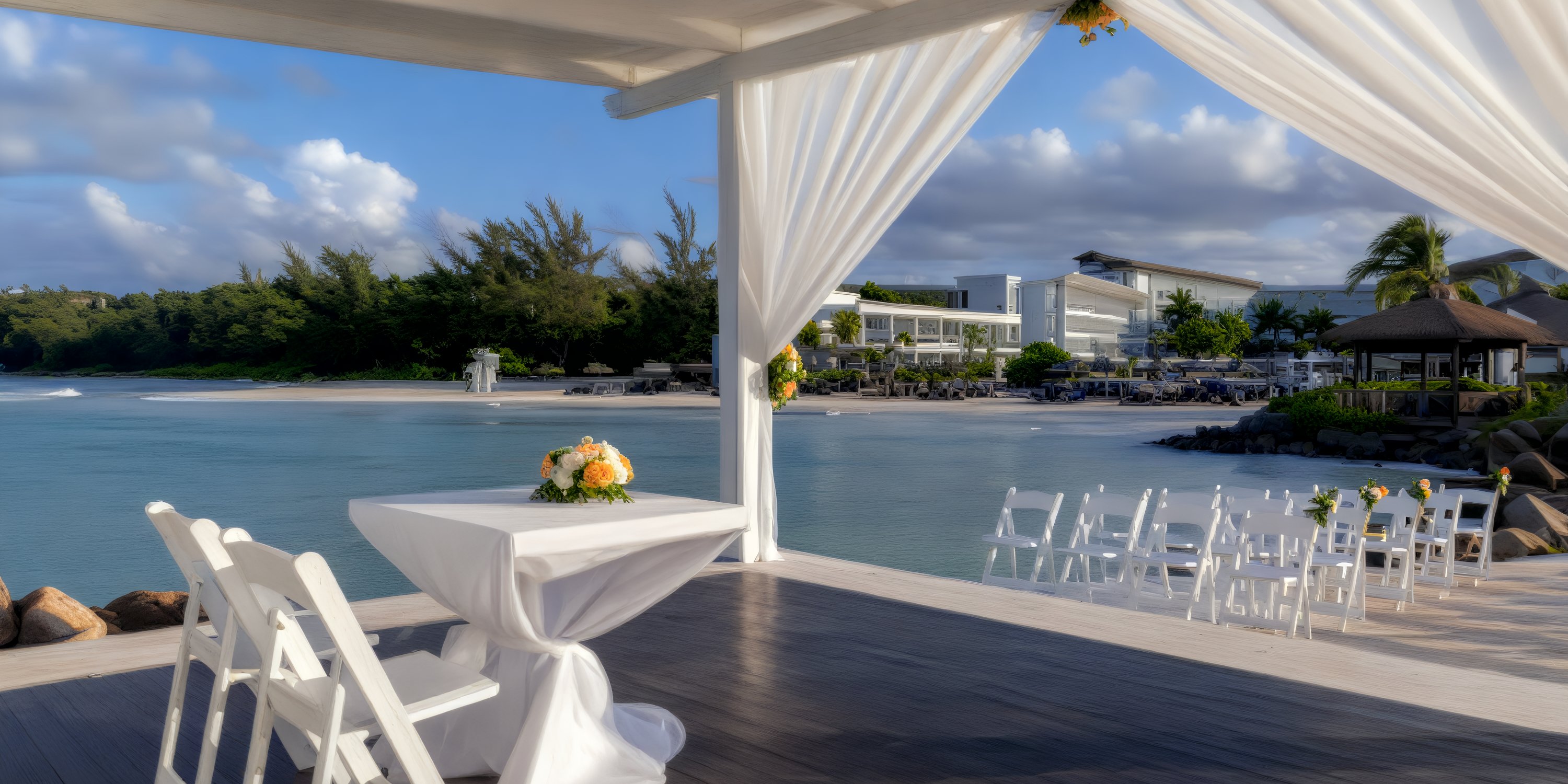 Destination wedding setup at Royalton Blue Waters with white chairs, canopy, and elegant floral decor.