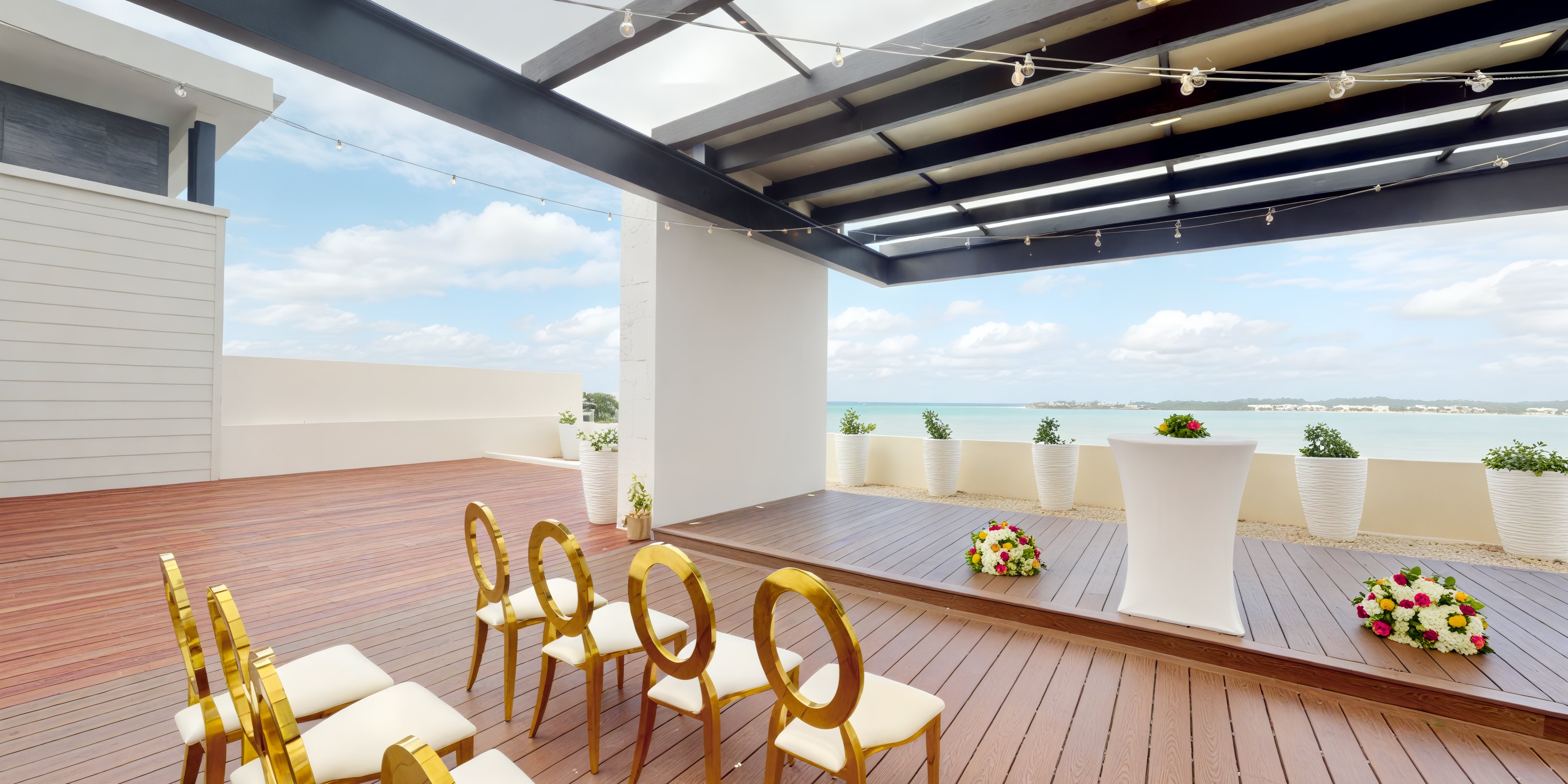 Royalton Negril offers a stunning rooftop deck, complete with chairs, flowers, and a podium, providing an idyllic setting for a destination wedding.