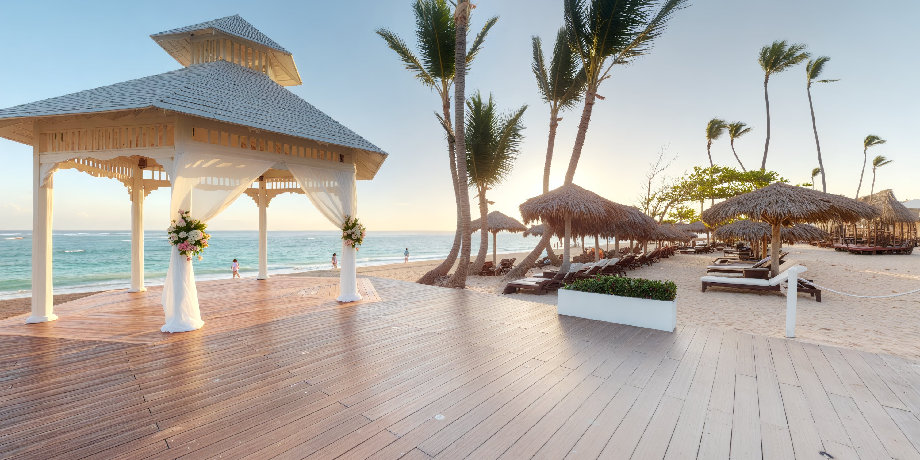 Royalton Bavaro beachfront gazebo set for a destination wedding, with lounge chairs and sunset-lit palms.