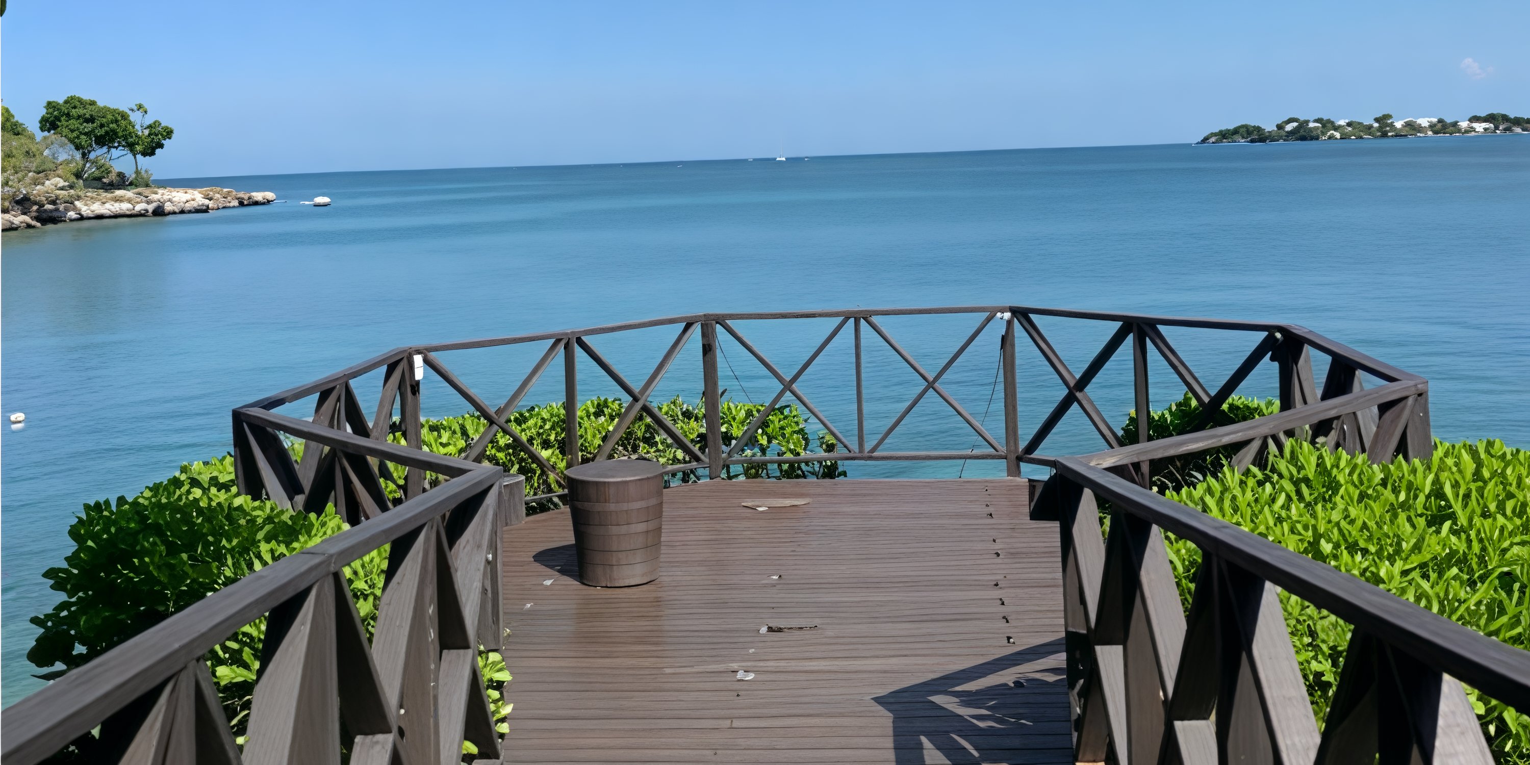 Wooden deck with railing at Royalton Negril, ideal for a destination wedding, overlooking calm blue sea.