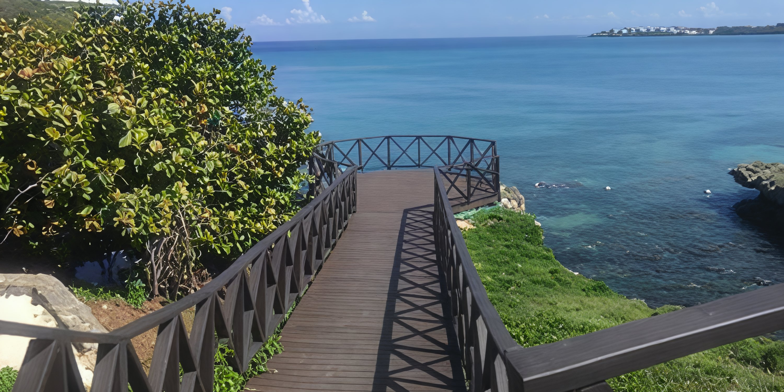 Wooden boardwalk leading to a Royalton Negril destination wedding platform overlooking the ocean.