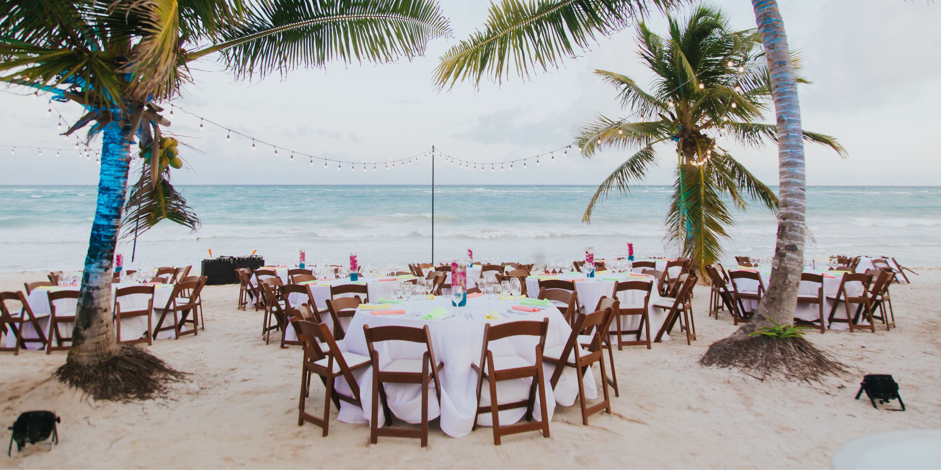 UNICO 20&deg;87&deg; Riviera Maya: Destination wedding tables on the beach with white cloths, palms, and lights.