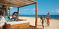 Beach sun beds and lounge chairs on beach at Dreams Punta Cana