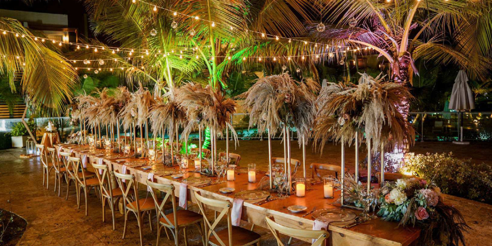Long table wedding reception at the pool at Dreams Onyx Punta Cana Dominican Republic