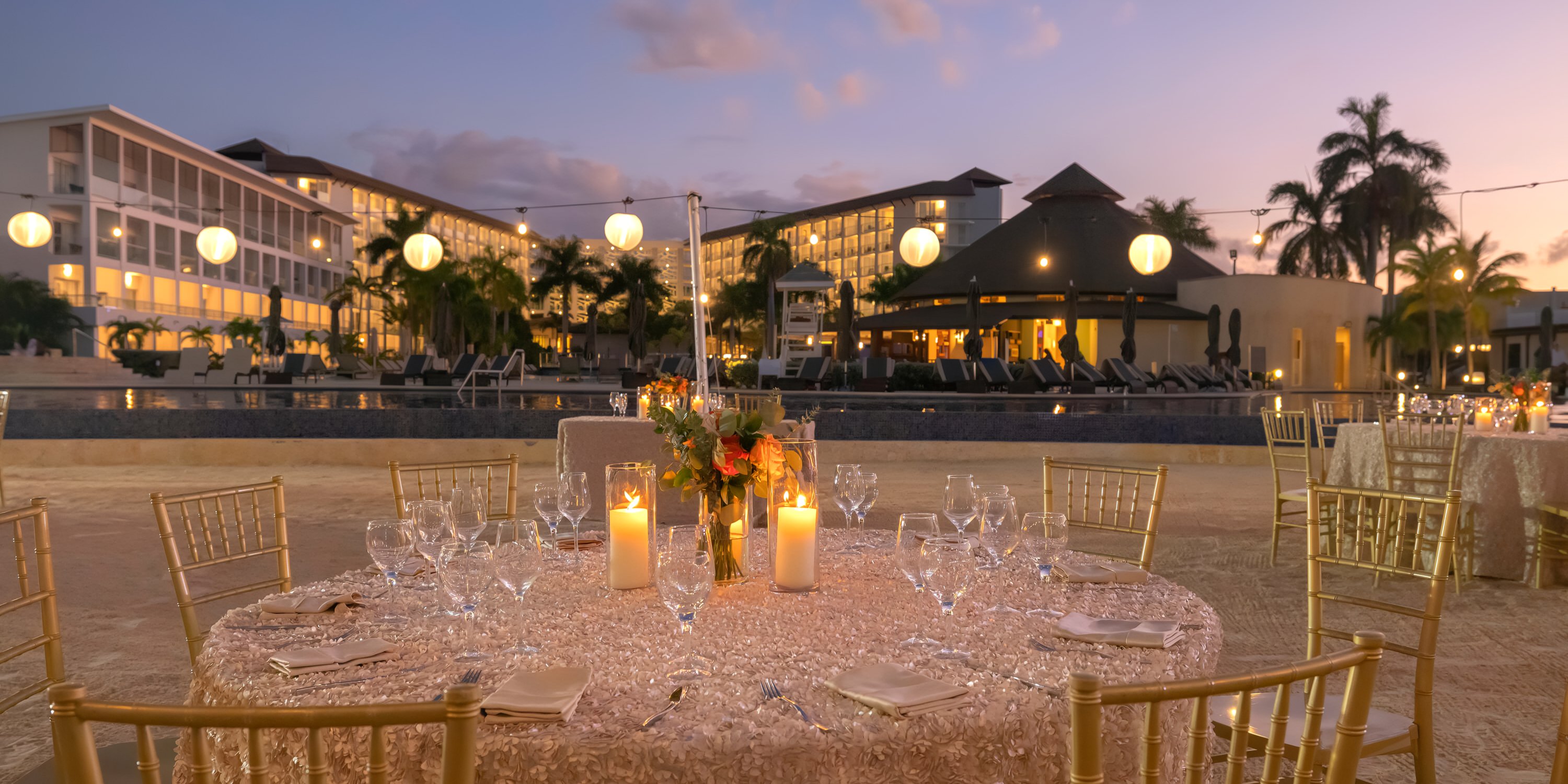 Candlelit poolside dinner at Royalton Blue Waters resort, perfect for a romantic destination wedding.