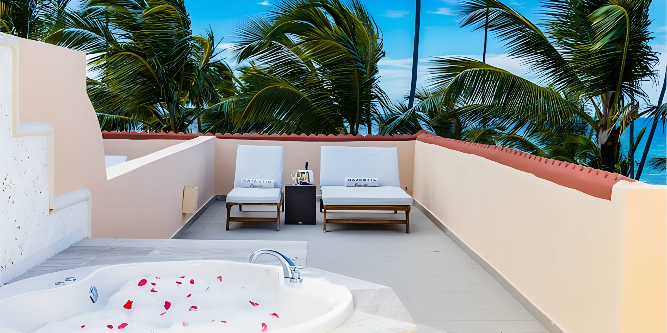 Private outdoor relaxation area with a hot tub and sun loungers surrounded by palm trees, ideal for Majestic Colonial destination weddings.