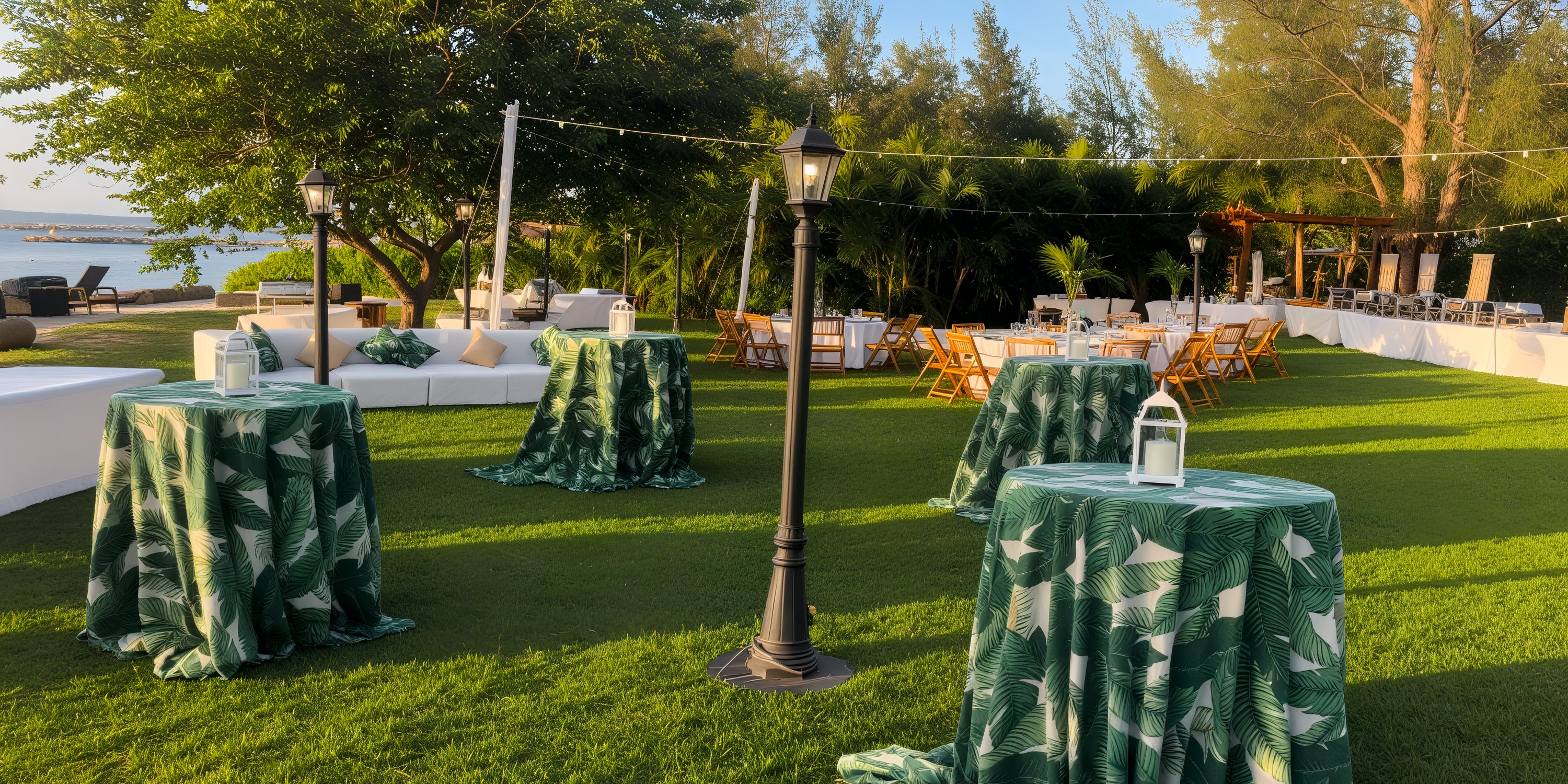 Breathless Montego Bay was beautifully arranged for the destination wedding, featuring tables and chairs covered in green tablecloths with lanterns artistically placed on the grass.