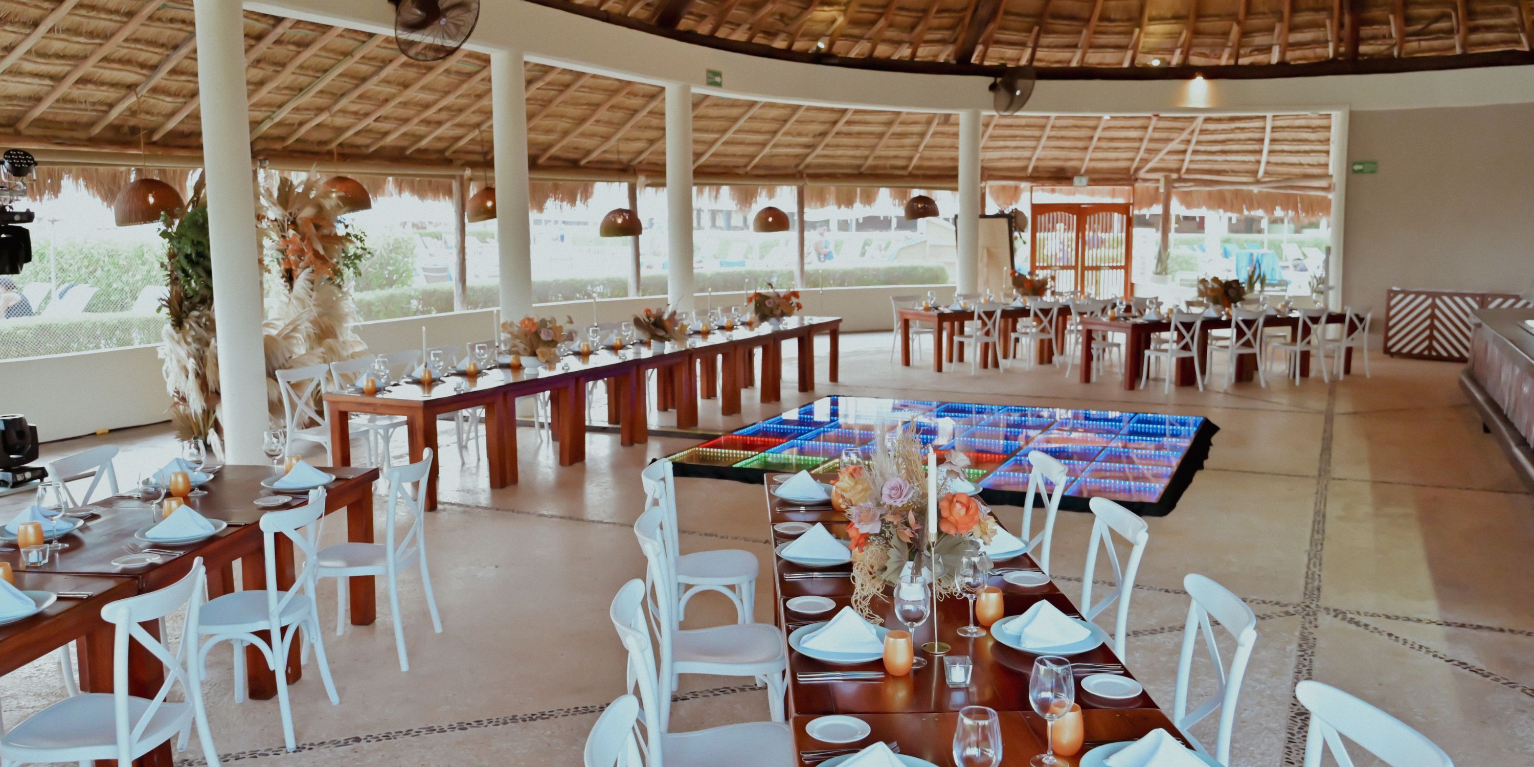 Catalonia Riviera Maya wedding hall set for a destination wedding, with tables, flowers, and dance floor.